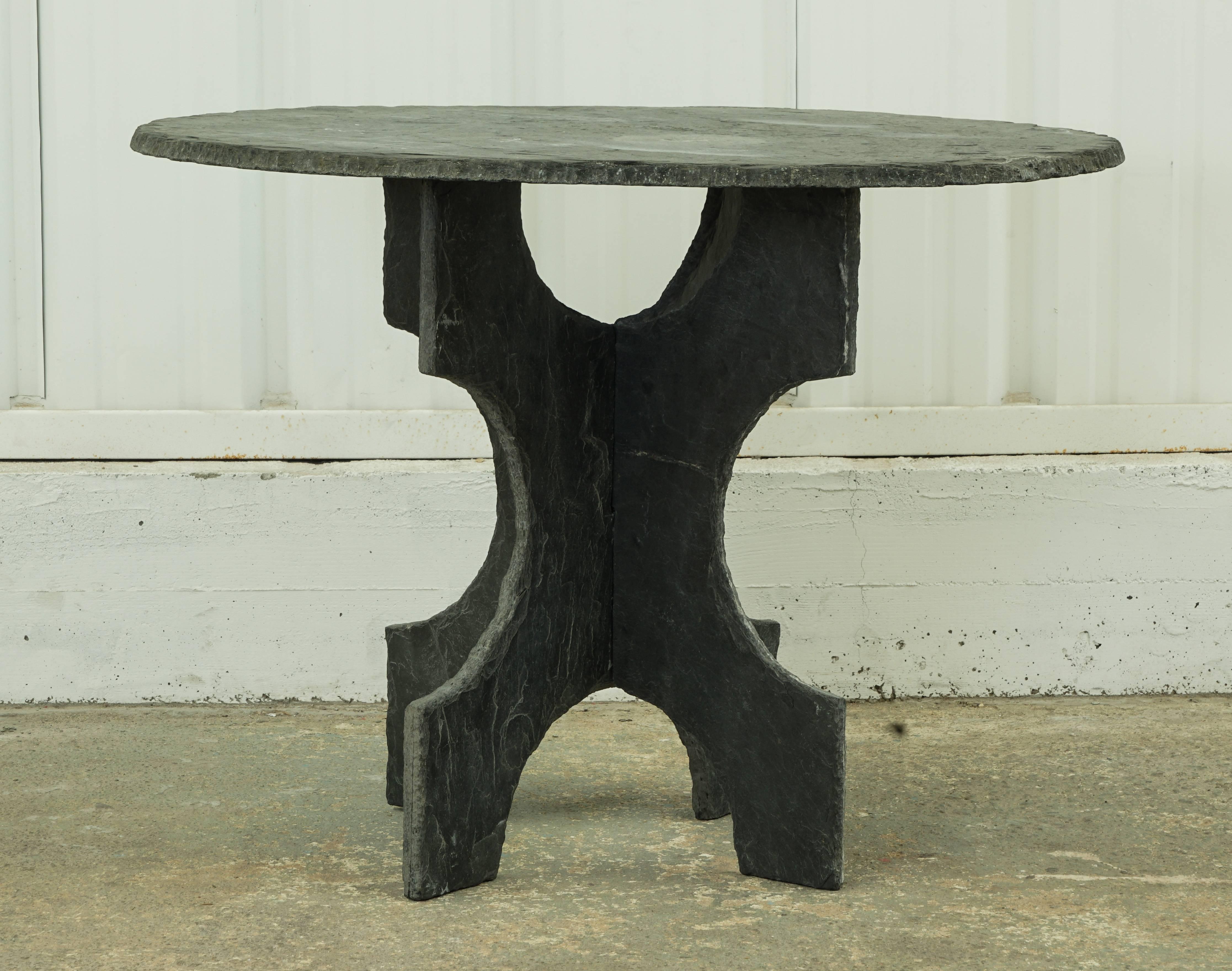 Round, black slate table from France, 1900s. Top and base are separate; base is two pieces that connect via grooves. Fabulous, patinated black slate with great texture.