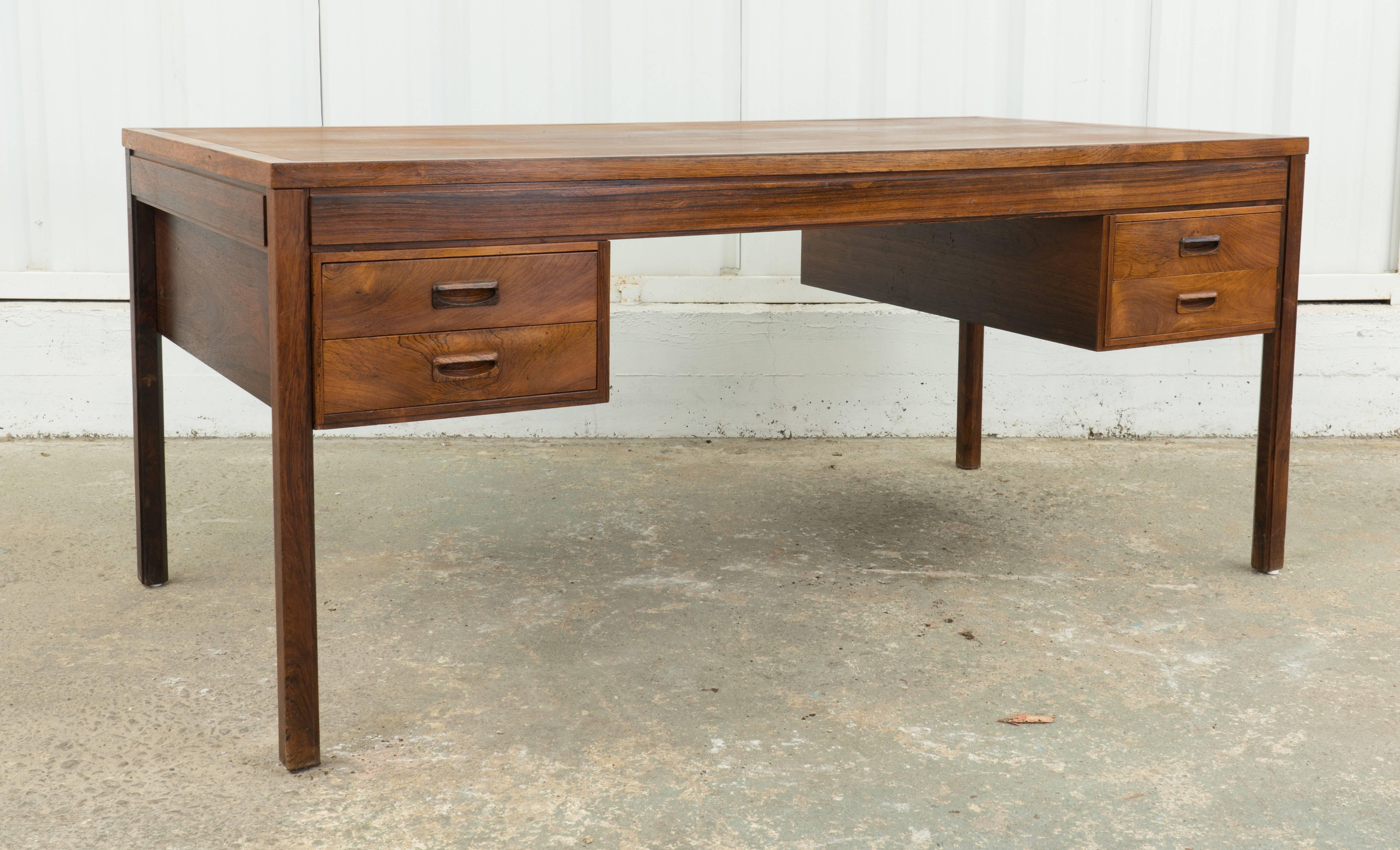Gorgeous rosewood desk made in Denmark by Soren Willadsen. Finished from 360 degrees so can easily float in a room. Beautiful lines and wood! See all pics for craftsmanship details and manufacturer notation.