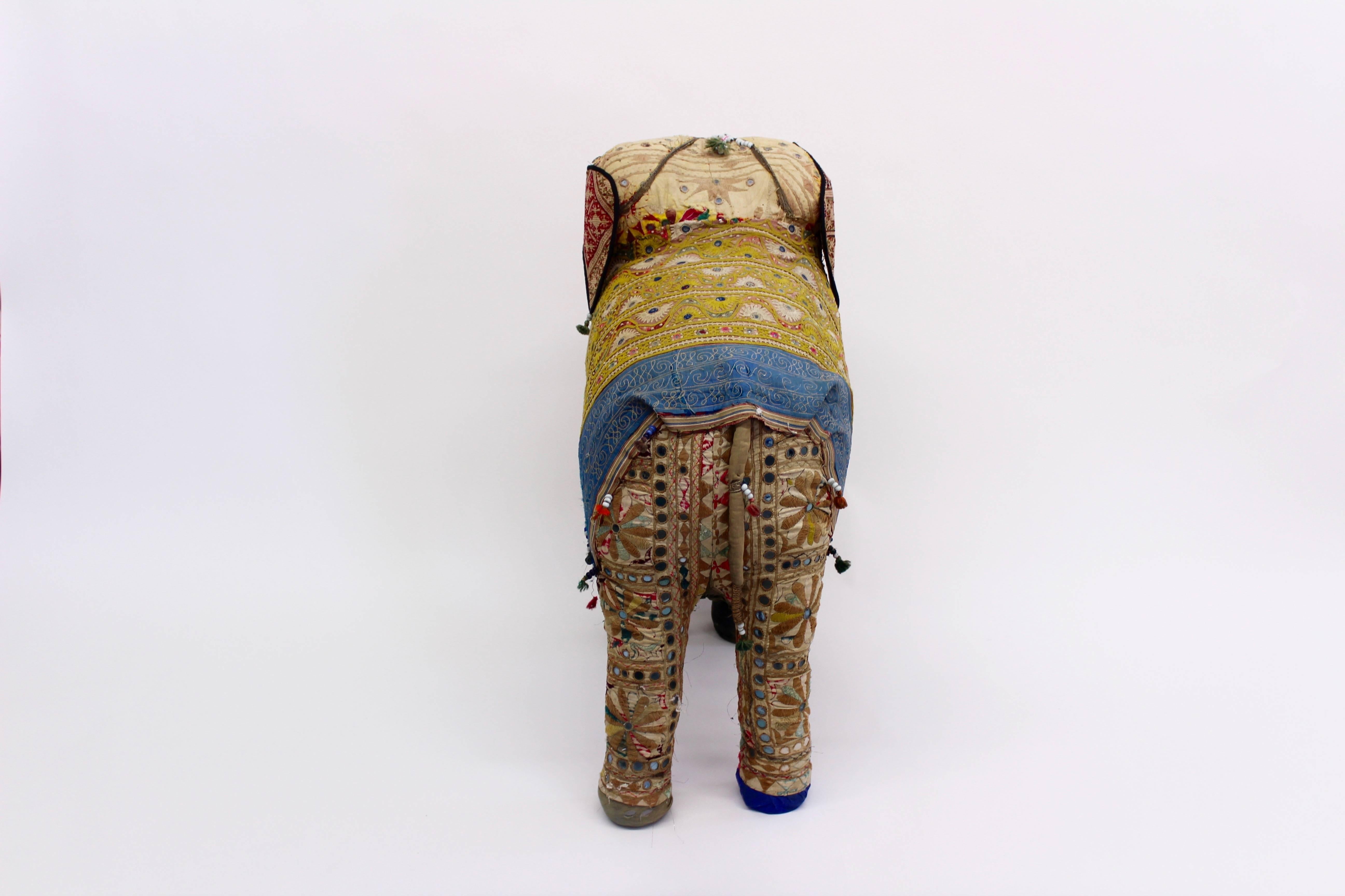 Whimsical, extra large, stuffed elephant covered in vintage textiles, beadwork and other embellishments. From India, 1950s.