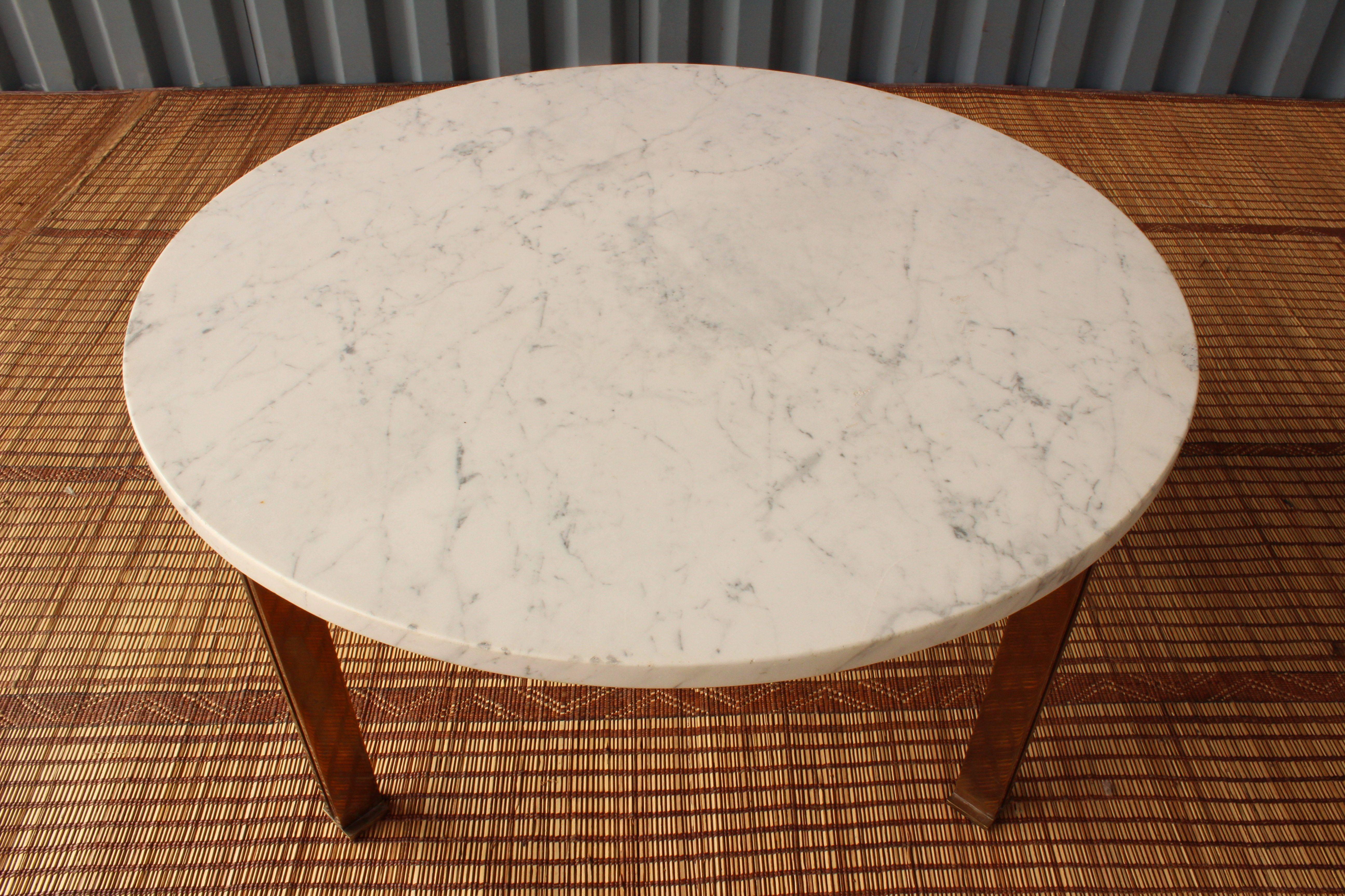 Vintage 1960s coffee table with solid bronze legs and a marble surface in the manner of Jacques Quinet. Bronze legs show age appropriate patina. The marble surface has minor wear as seen in photos.