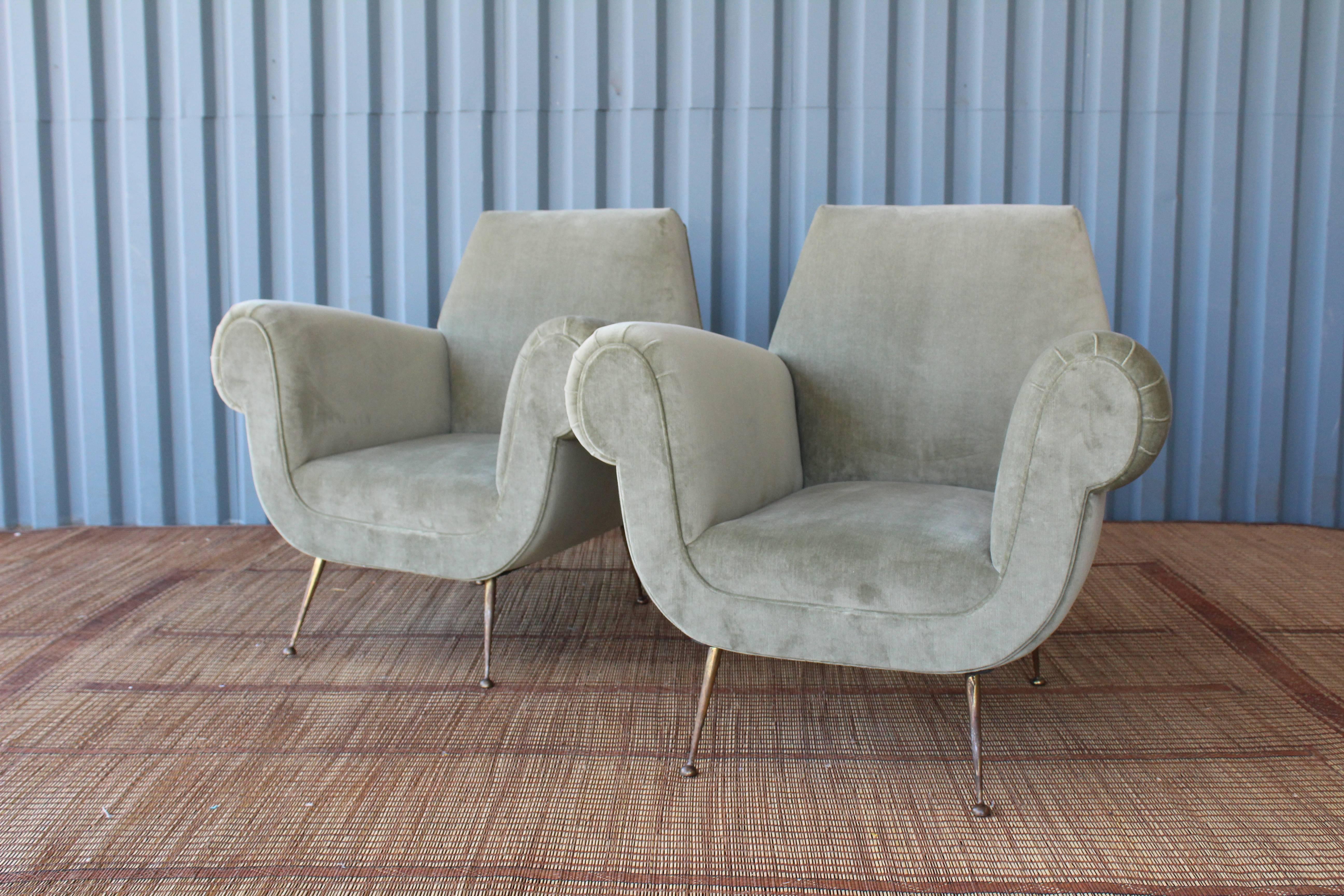 Lovely pair of 1950s Italian modern armchairs. Newly reupholstered in sage green velvet. Solid brass stiletto legs which have a wonderfully aged patina. In the manner of Gigi Radice for Minotti.
 