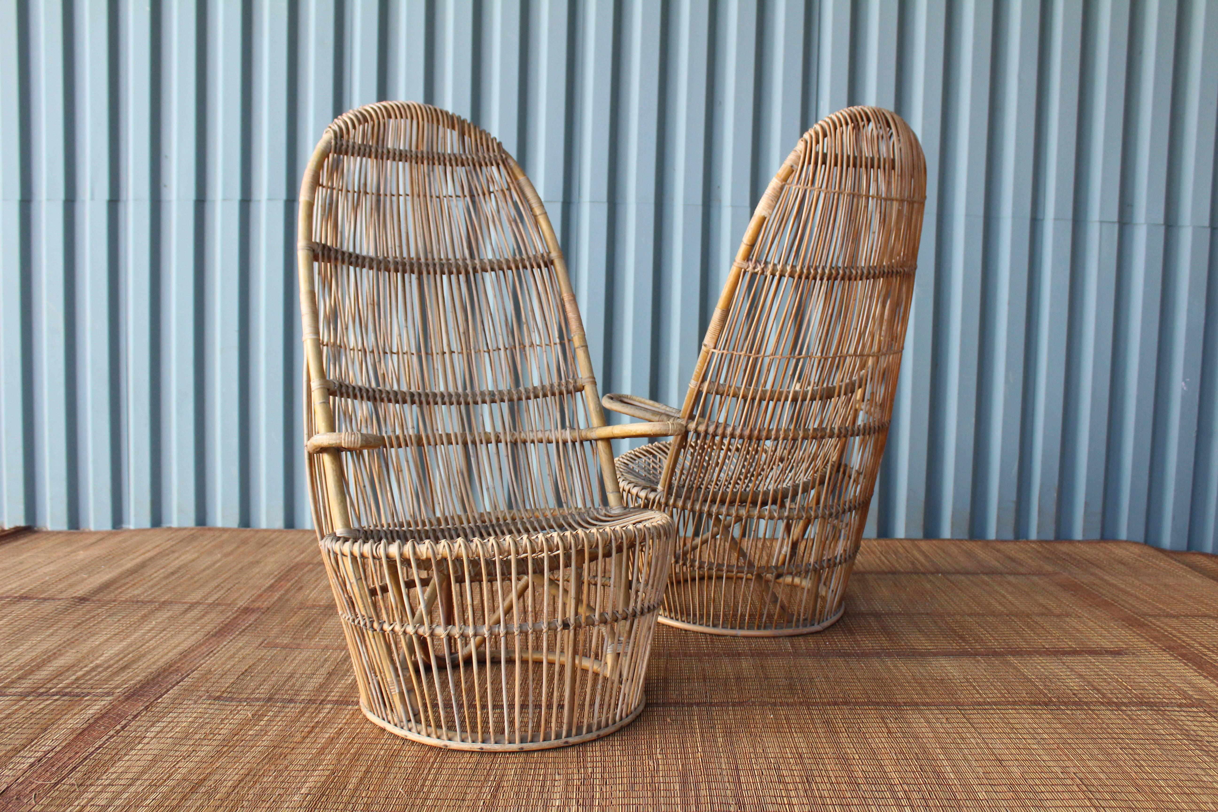 A pair of 1960s Italian high back rattan chairs. The pair are structurally sound and show age appropriate patina.