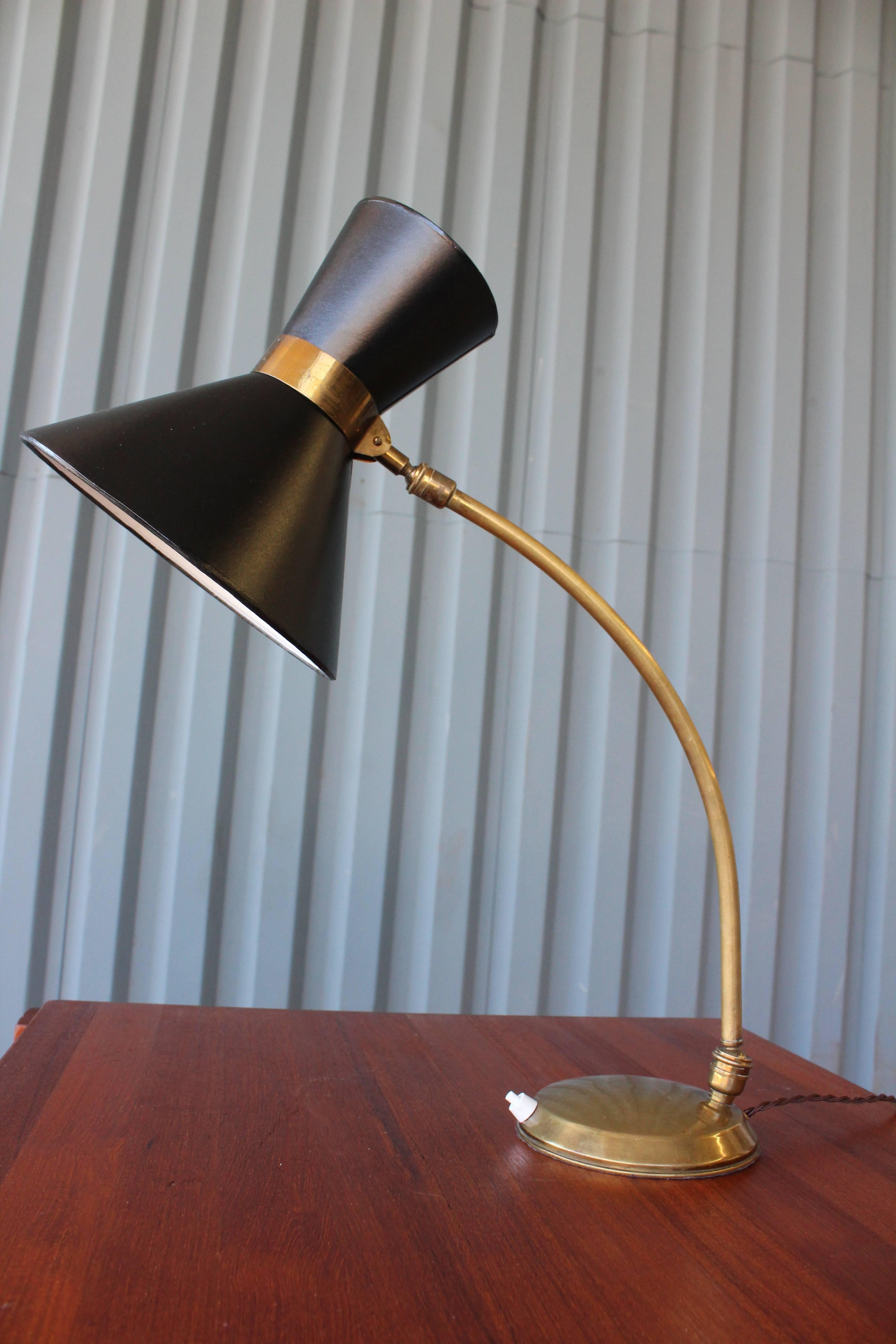A midcentury Italian double cone brass desk lamp with adjustable head. Features new custom-made shades. Newly rewired for U.S standards.