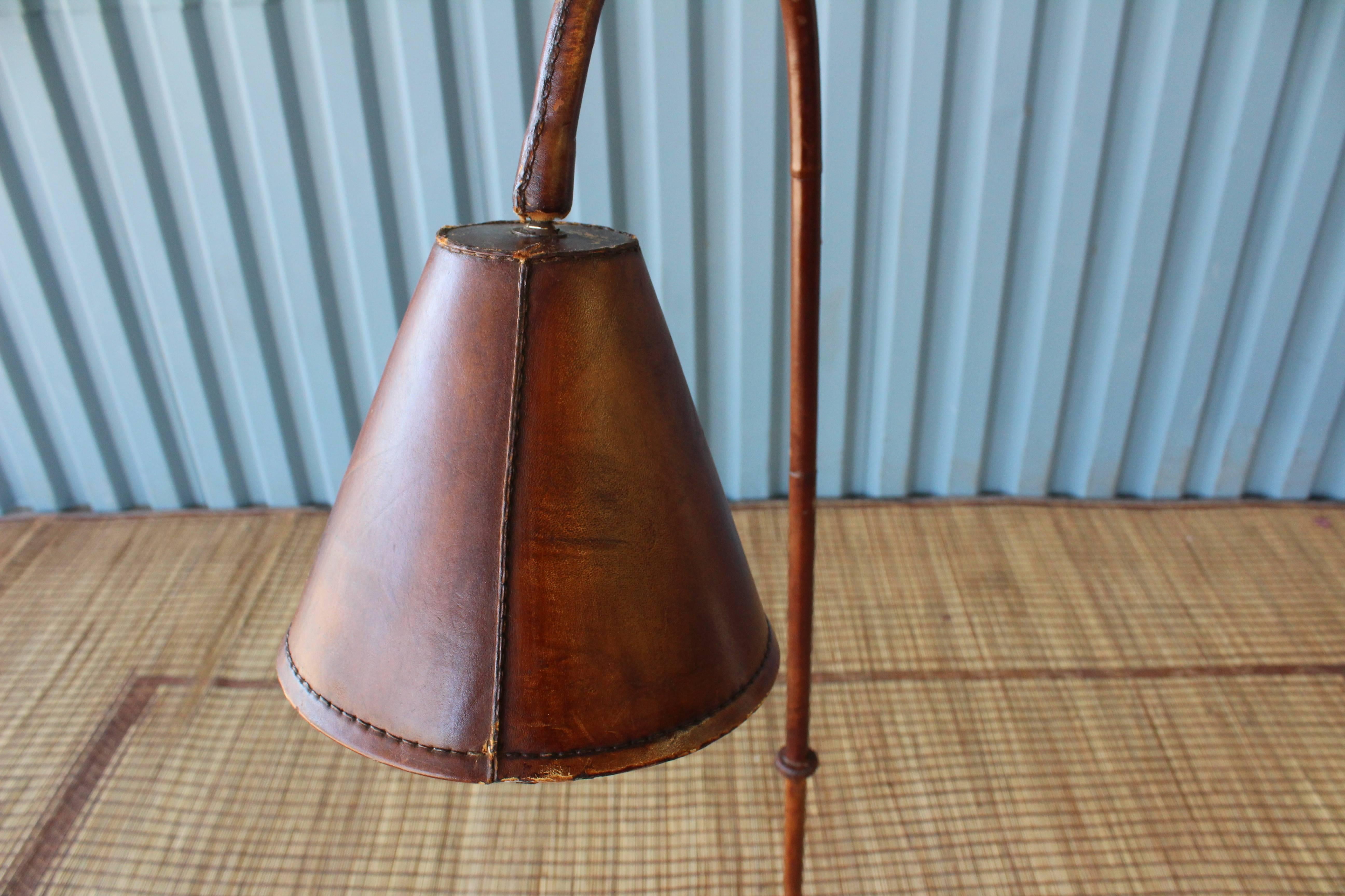 A brown leather-wrapped floor lamp by Valenti, Spain, 1950s. Leather shows age appropriate wear and patina. Newly rewired for U.S standards.