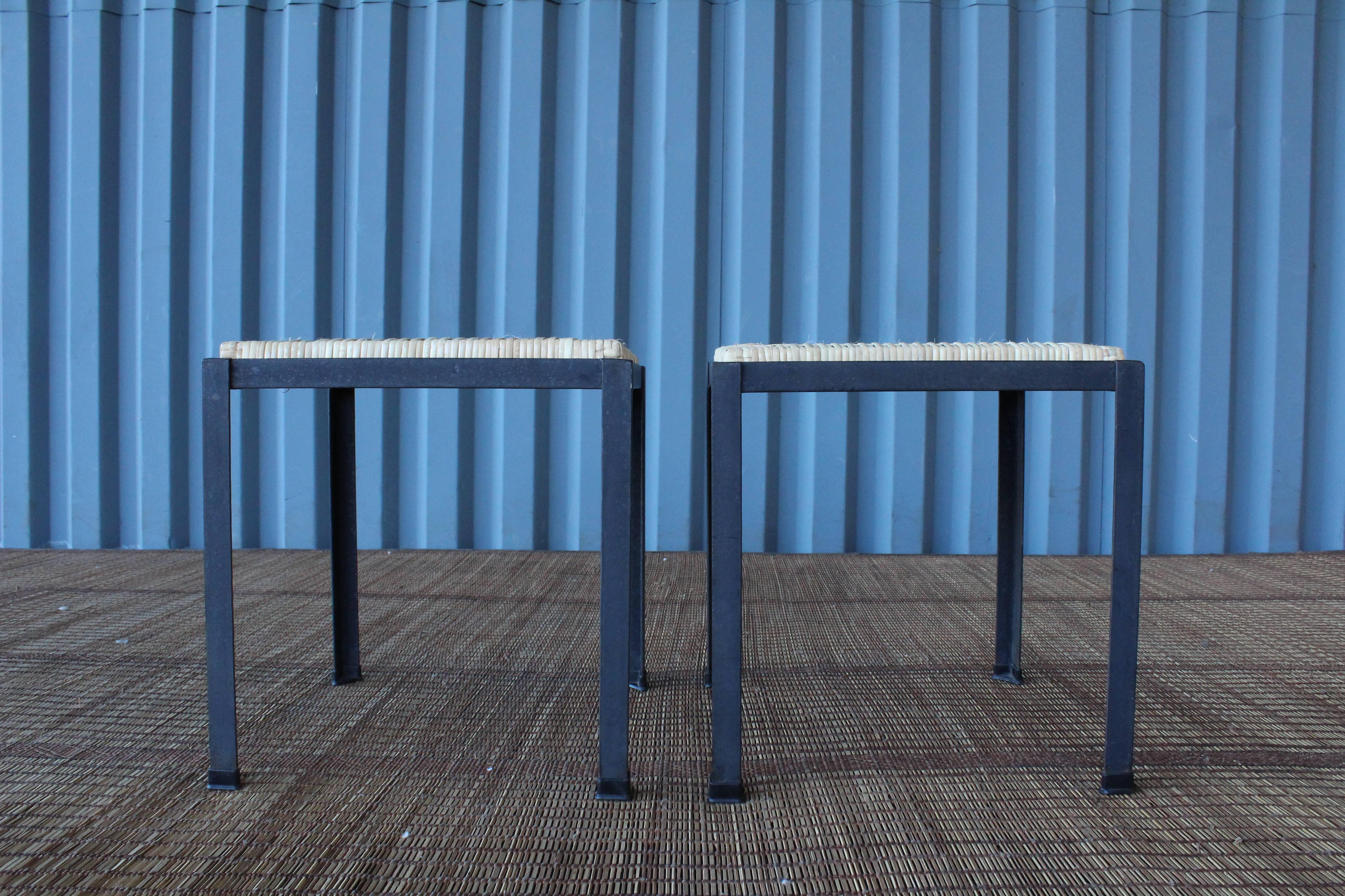 Pair of simple, stacking iron stools with newly caned seats by Danny Ho Fong for Tropi-cal, California, 1950s.
