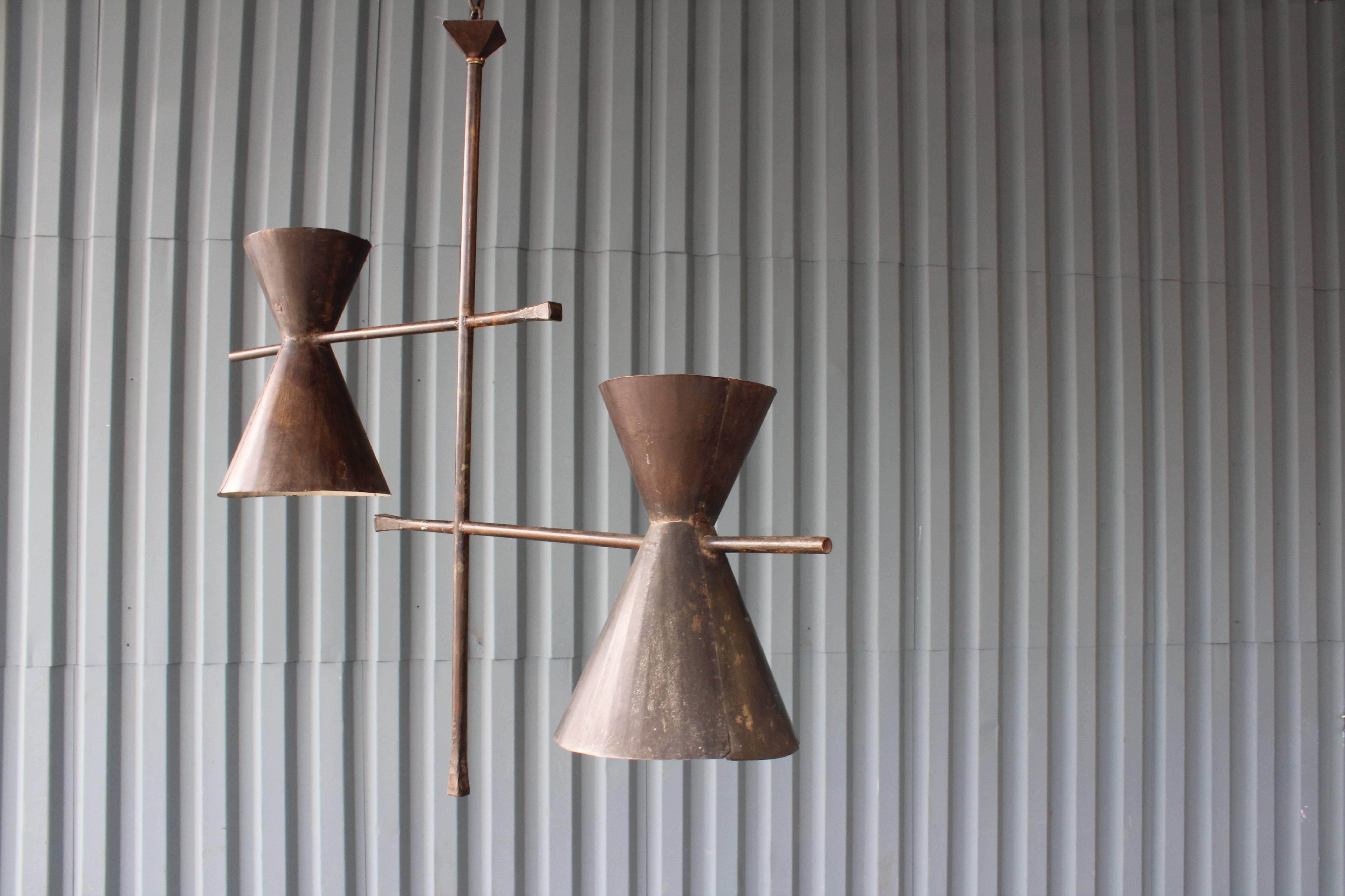 A modern Industrial style ceiling pendant from France, 1950s. Iron rods with steel shades with original dark brown finish. Newly rewired for U.S standards.