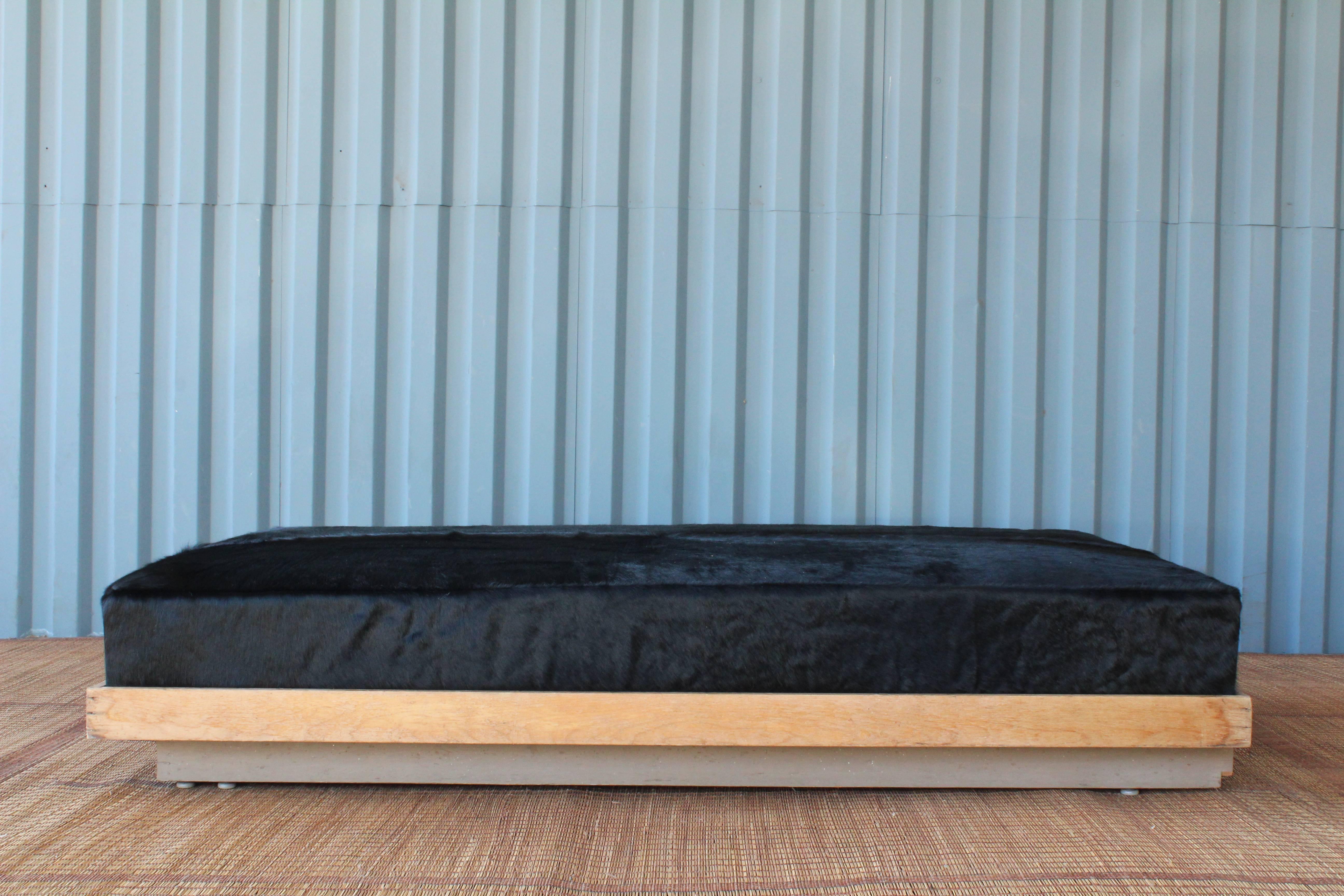 Authentic plinth base daybed by Richard Neutra, salvaged from a home by the architect. We kept this base in it's original condition and created a cushion in black cowhide. This piece would be perfect as a daybed but could also work as a coffee