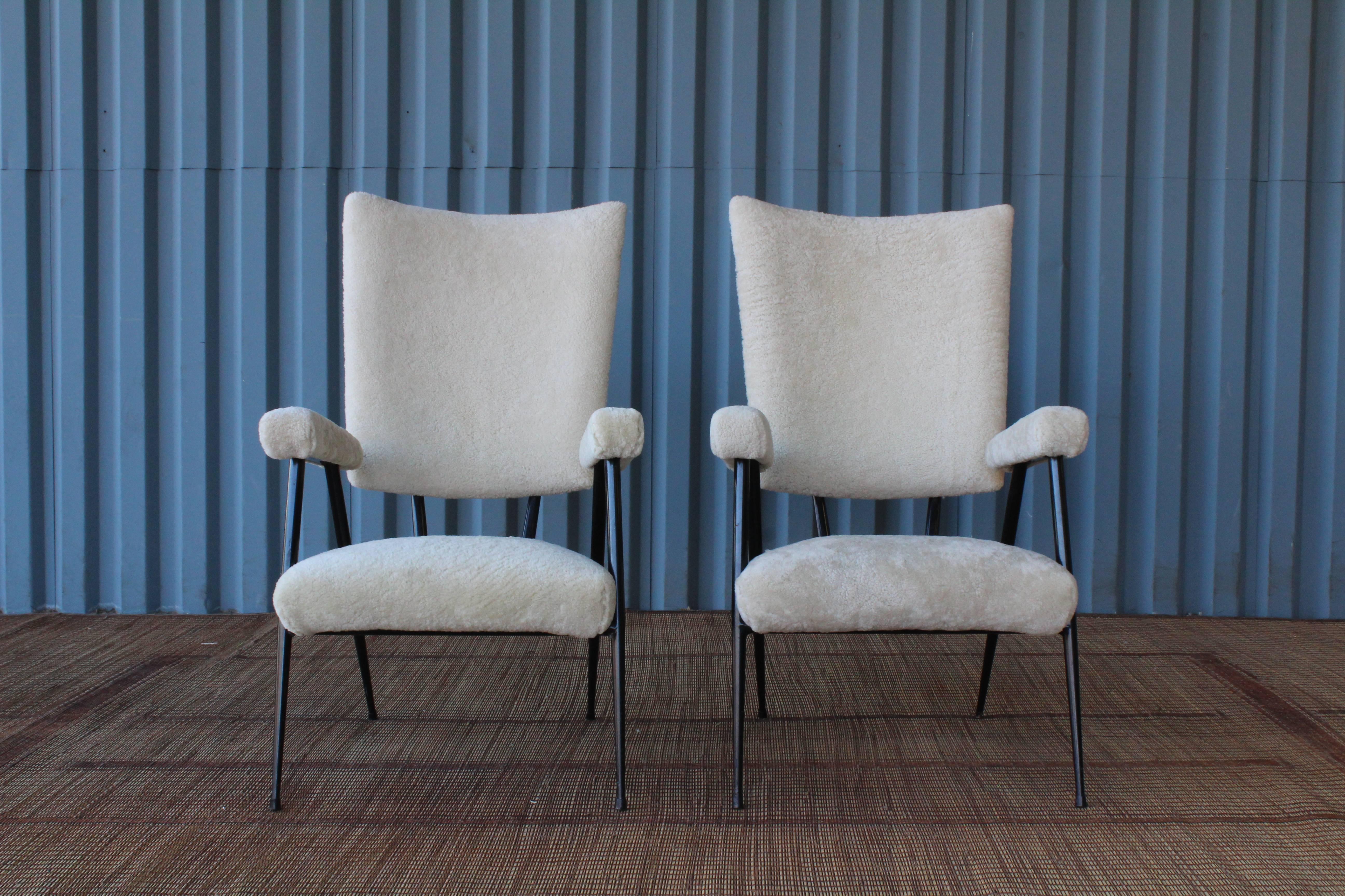 Unique pair of steel framed high back chairs, in the manner of Gastone Rinaldi. These feature new plush sheepskin upholstery.