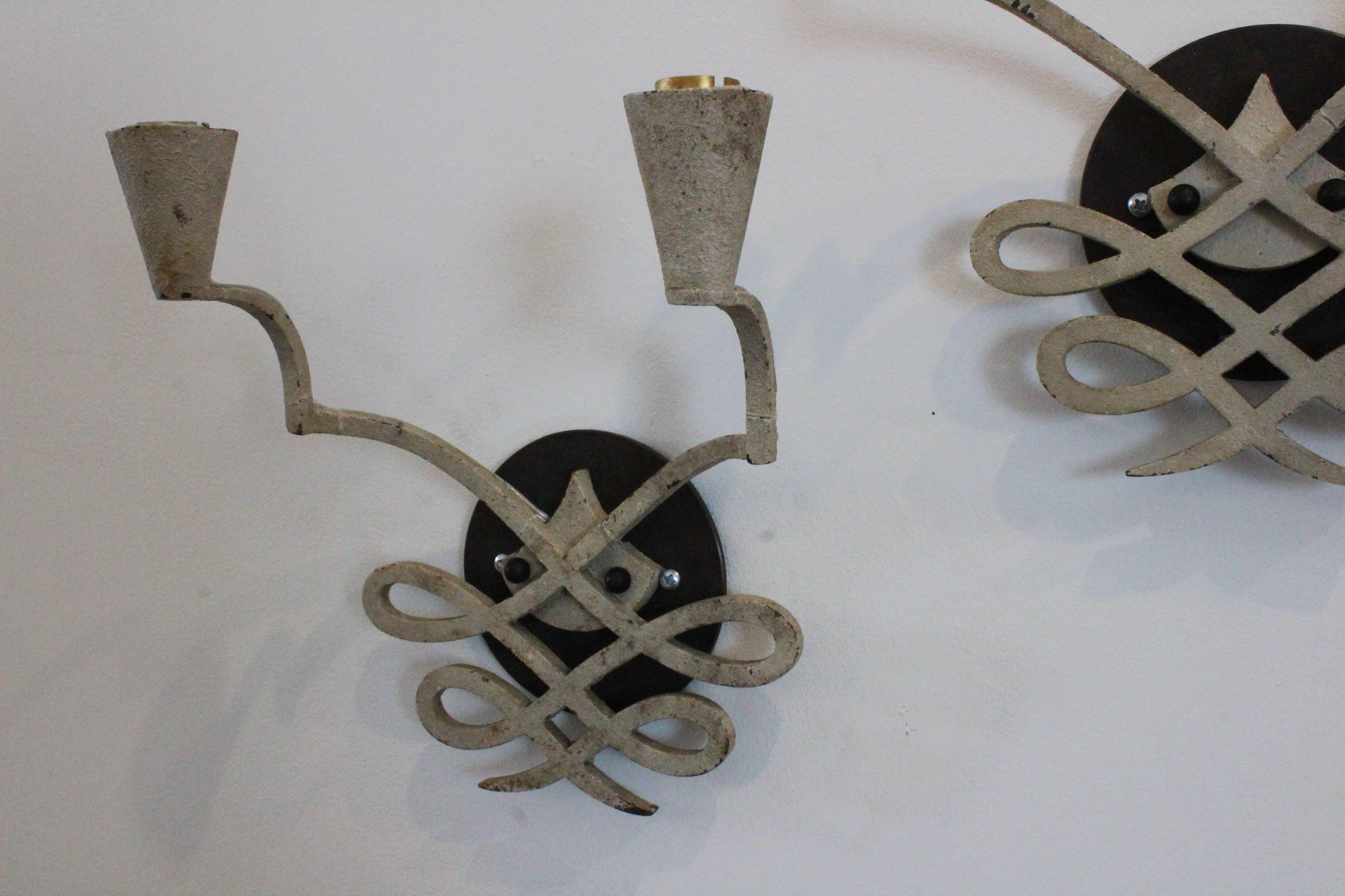 Pair of 1940s French iron sconces with original white finish. These have a beautiful patina and have been recently rewired.