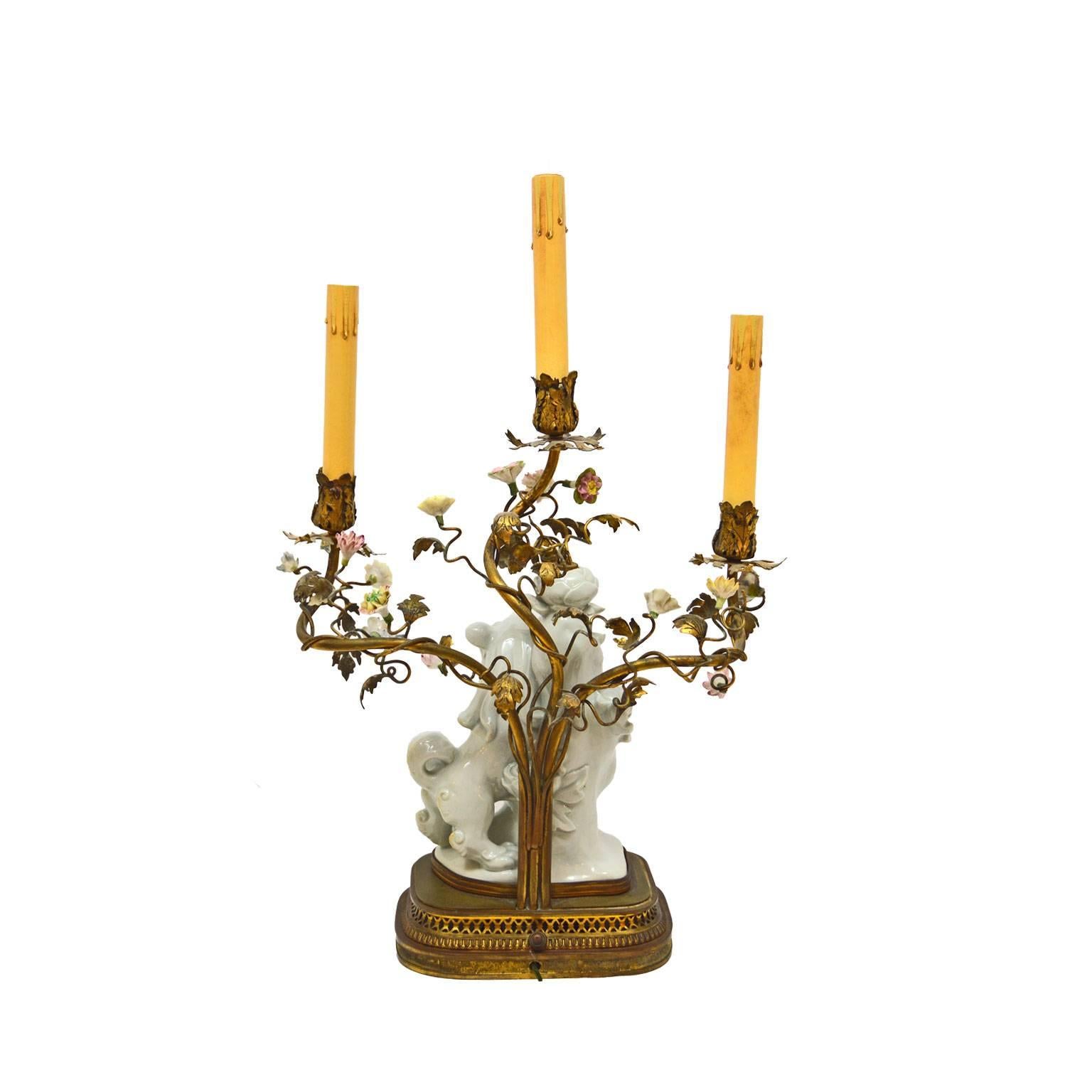 19th century porcelain foo dog candelabra featuring French porcelain flowers and imported Chinese foo dogs on a bronze base. The lamp has been electrified.