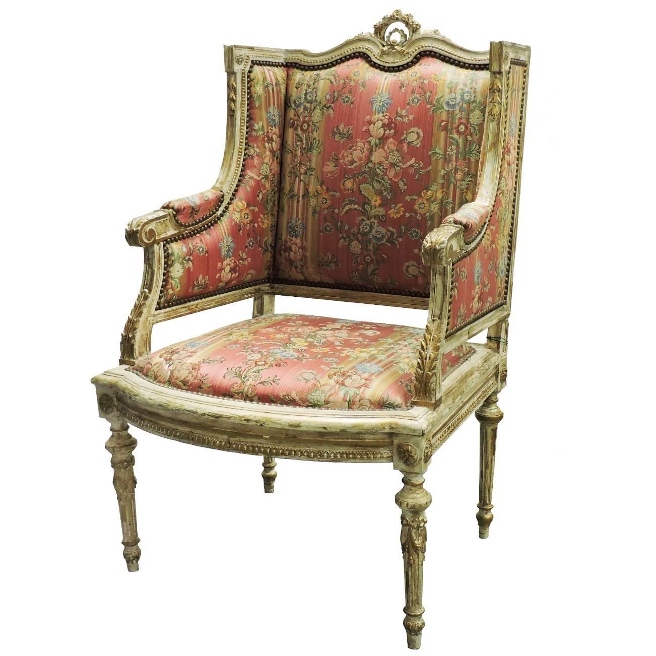 This beautiful Italian period piece was bought in Paris. This chair was originally entirely gilded, and now brushed with white finish over gilding. The original horse hair cushions remain intact, however upholstery has been redone in a Scalamandre