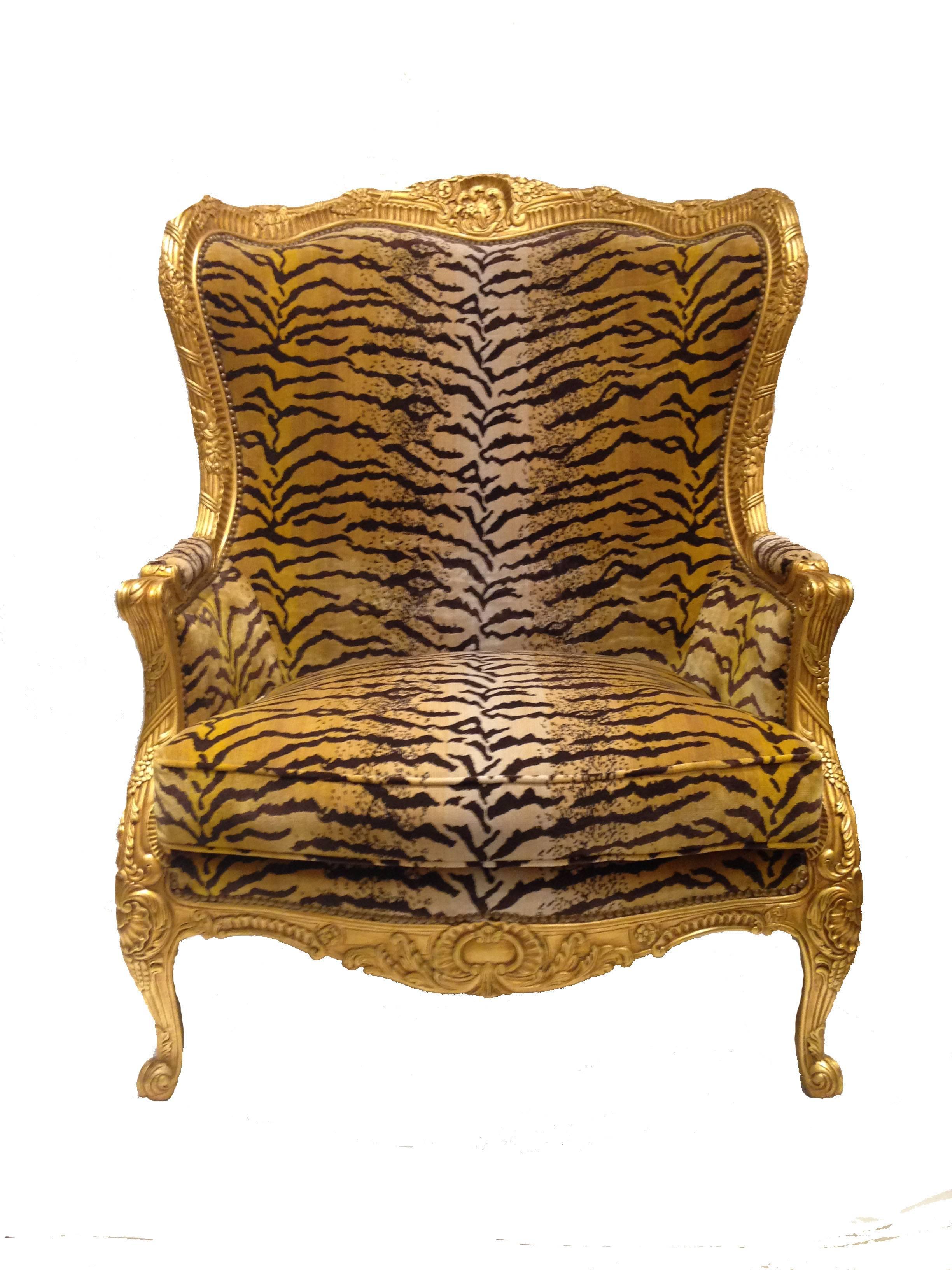 Majestic scaled, hand-carved gold leafed frame French chair. Upholstered in tiger velvet with nailhead trim. Includes two down filled matching throw pillows. 

Dimensions:
Chair: 37