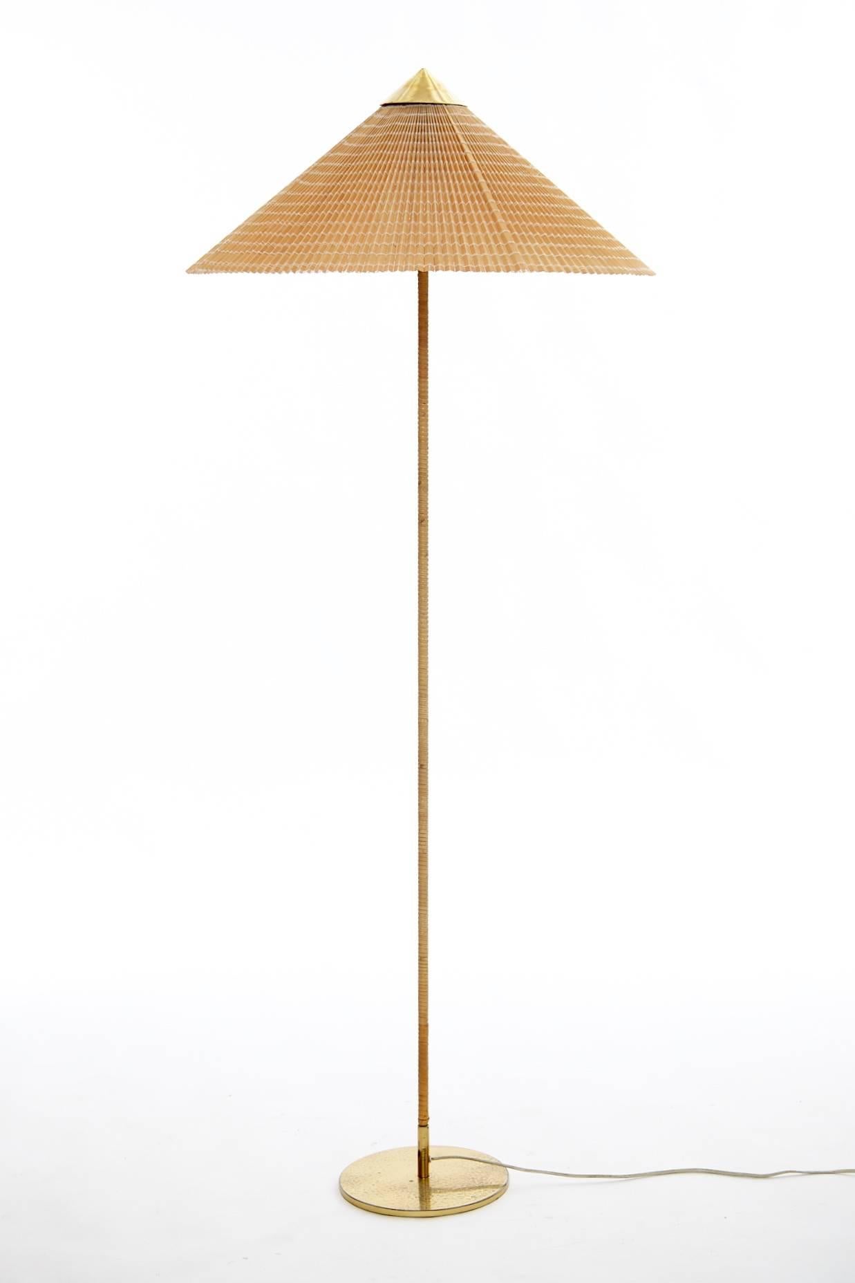 Paavo Tynell floor lamp, model 9602, for Taito or Idman, Finland, circa 1940s.
Solid brass, metal, original rattan and later shade.  Unmarked.