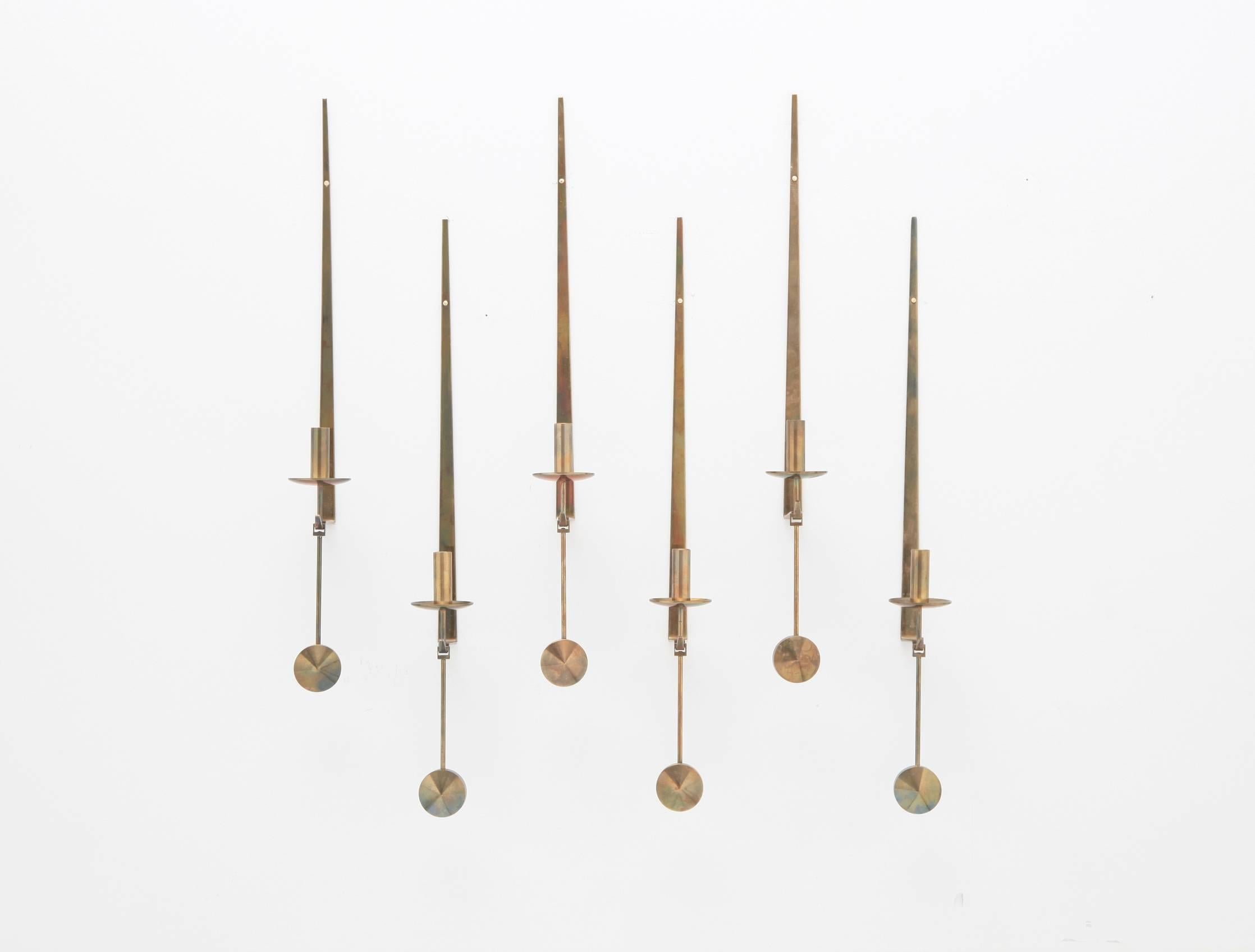 Pierre Forsell designed brass pendel wall appliques, collection of six. Rarer version with bobeche. Made by Skultuna, Sweden, circa 1965. In beautiful original patinated condition. Stamped with makers mark.

Measures: 2 W x 3.25 D x 19 H inches.