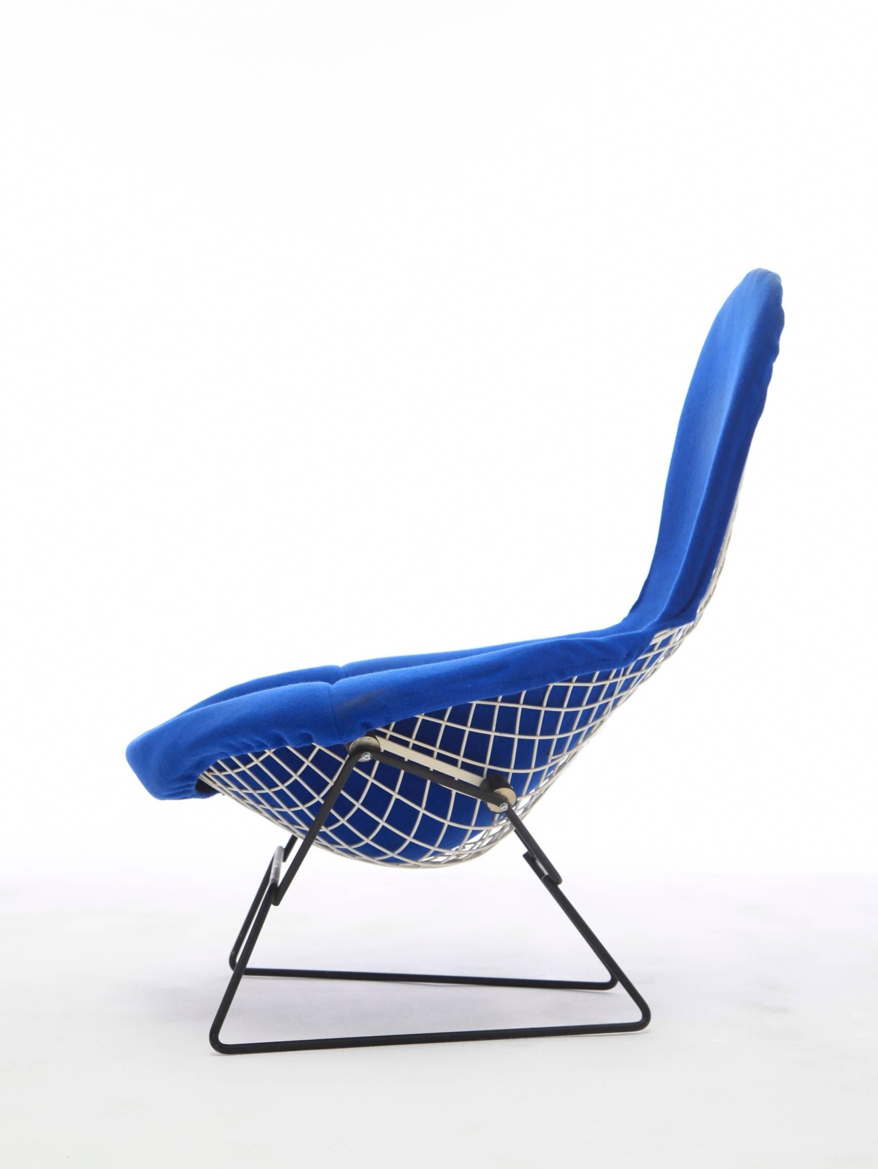 Harry Bertoia bird chair and footstool, for Knoll International, made from lacquered steel rods. Rare black and white model. Chair and ottoman in electric blue upholstery. Good structural condition. Some minor enamel loss on chair.