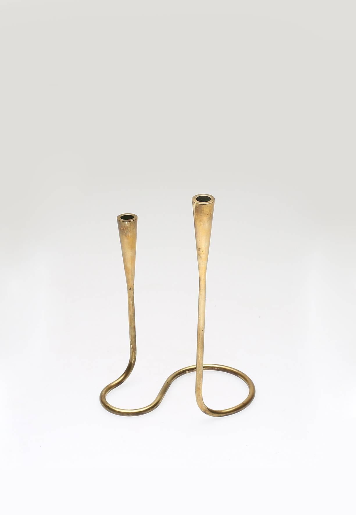 A brass double ended Serpentine candlestick by Illums Bolighus, Denmark, circa 1950s.  Ships worldwide.