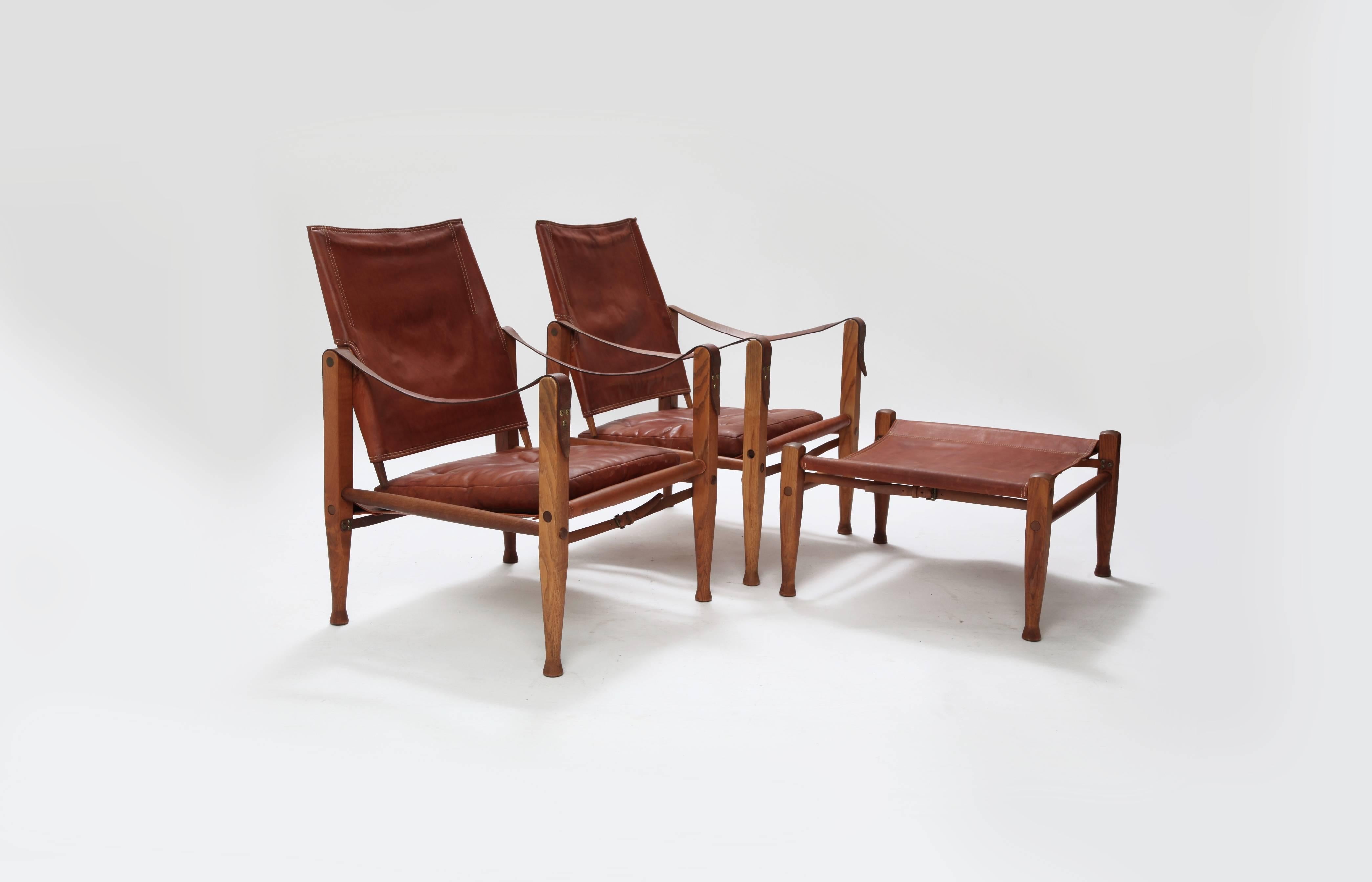 * complimentary US shipping during January *

A rare pair of safari chairs and matching foot stool designed by Kaare Klint. Ashwood frame and patinated original leather. Designed in the1933 by Kaare Klint for Rud. Rasmussen. The second chair has