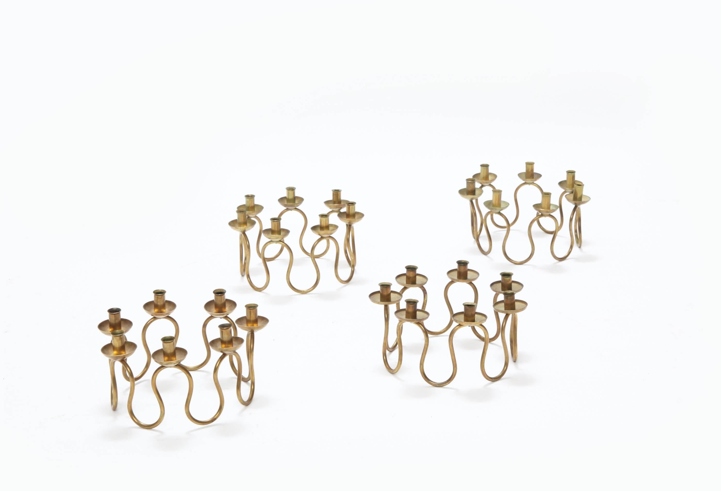 Brass candlesticks designed by Lars Holmström for Firma Svenskt Tenn, Sweden.   

Diameter 18.5cm.