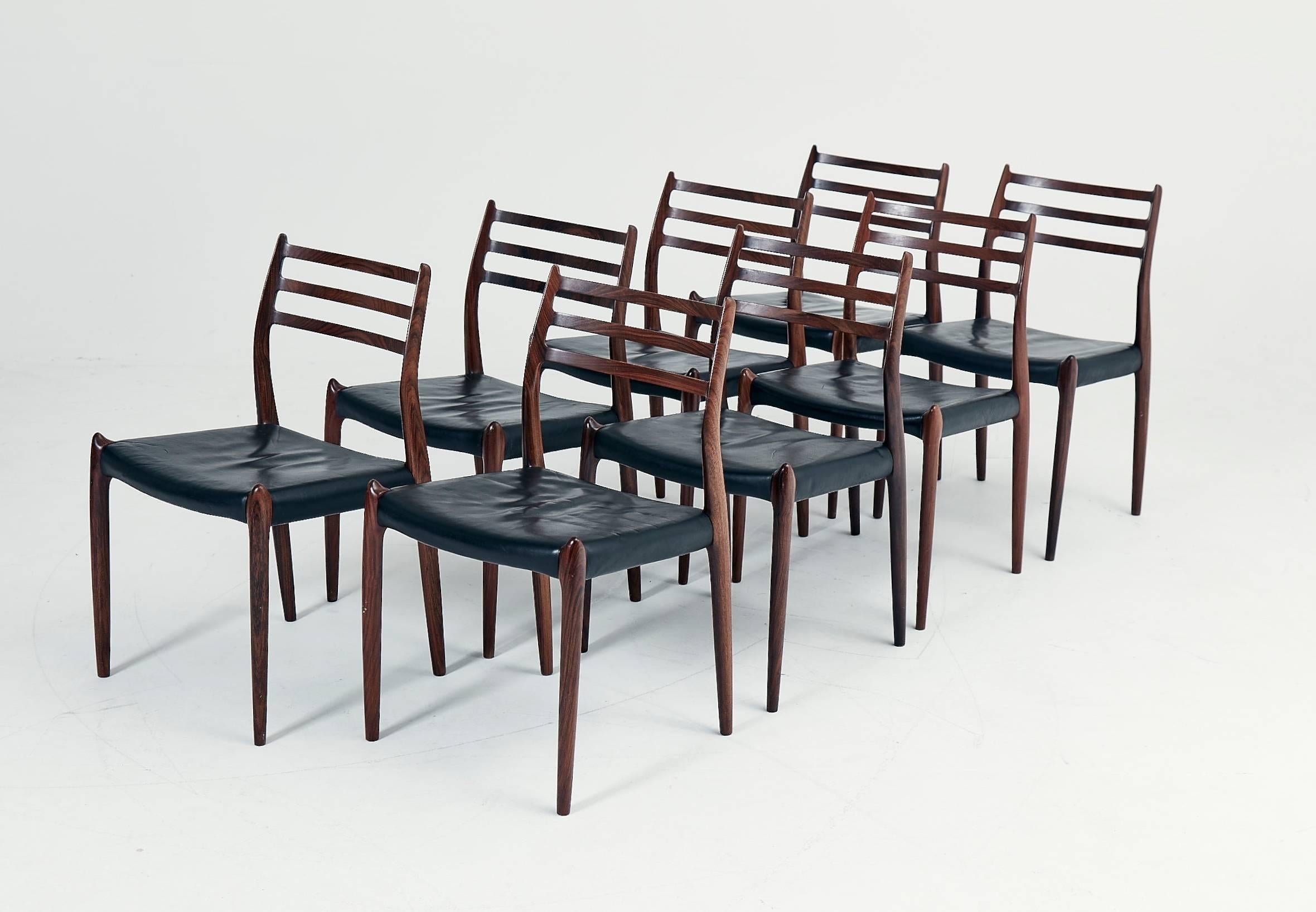 A set of eight rosewood N.O. Møller 78 side chairs. 1962 for J.L. Møllers Møbelfabrik, Denmark. Rosewood, original black leather seat covers. Excellent condition. Ships worldwide. More photos on request.
