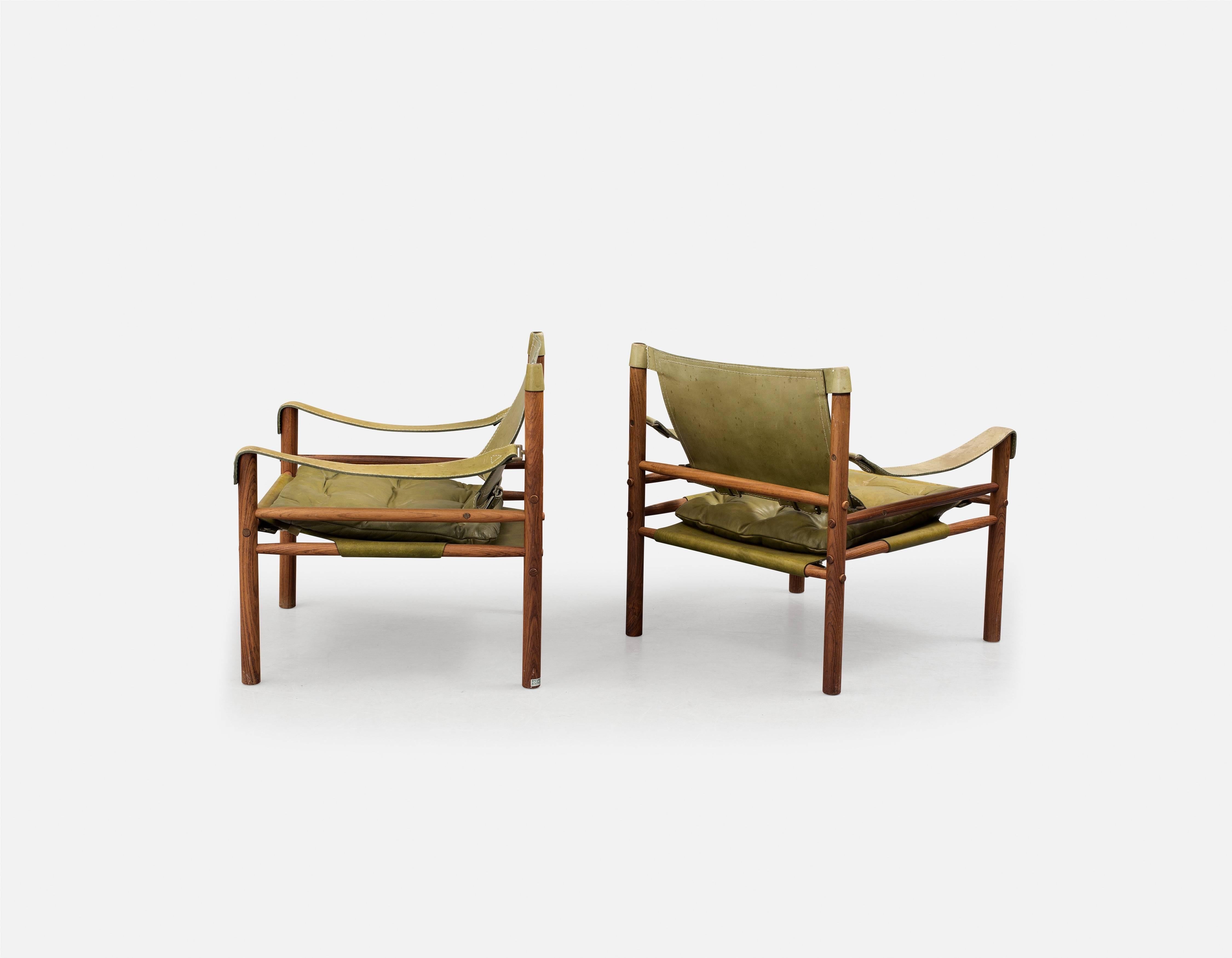 A beautiful original pair of Arne Norell safari sirocco chairs in rosewood and green leather, 1960s, Sweden. Made by Aneby Mobler, with makers label attached. Fast and inexpensive shipping worldwide.