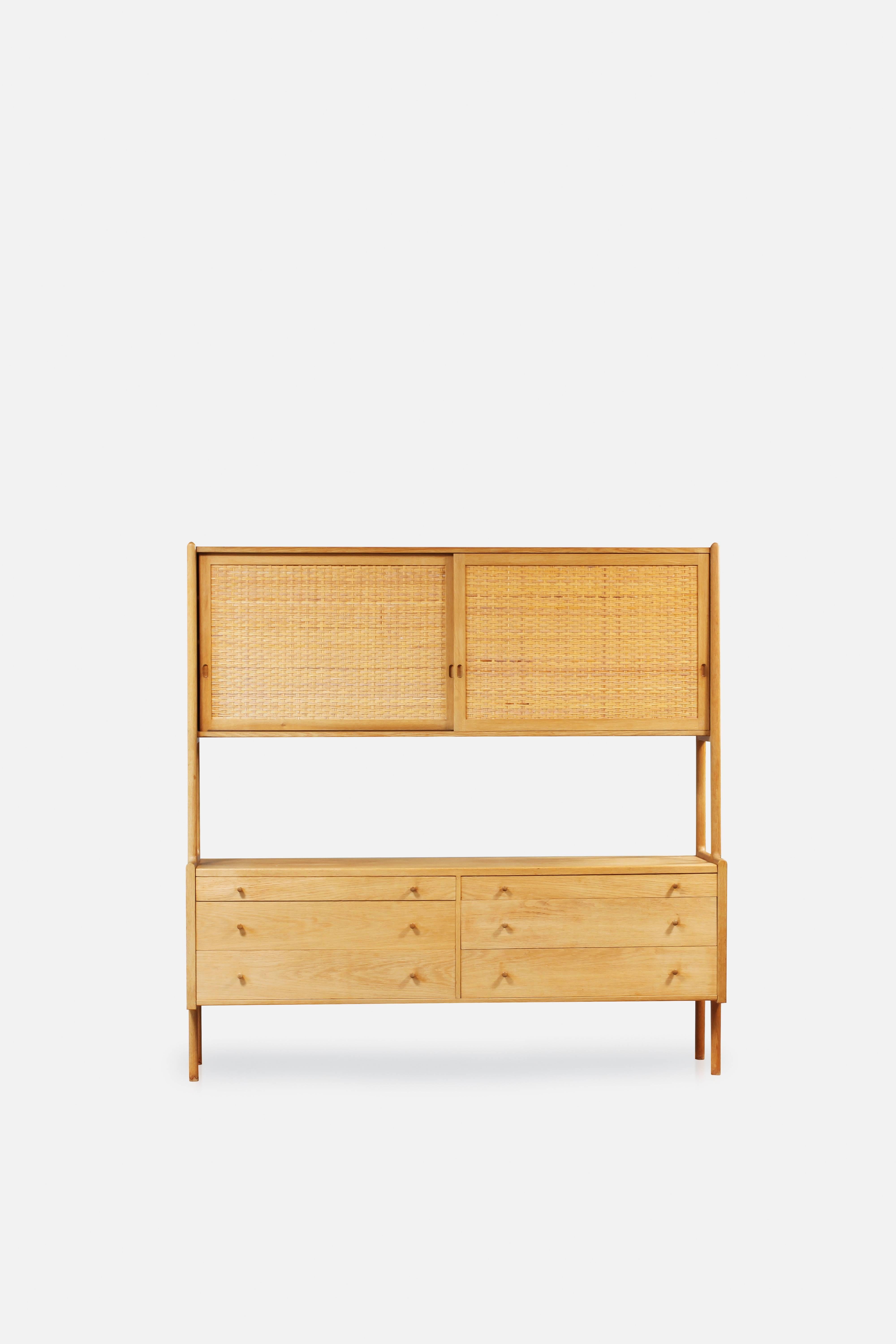 Rare original Hans J Wegner cabinet model RY-20, oak and cane, Ry Mobler, Denmark. Stamped 26 August 1959.

Length 180 cm, depth 49 cm, height 180 cm.

