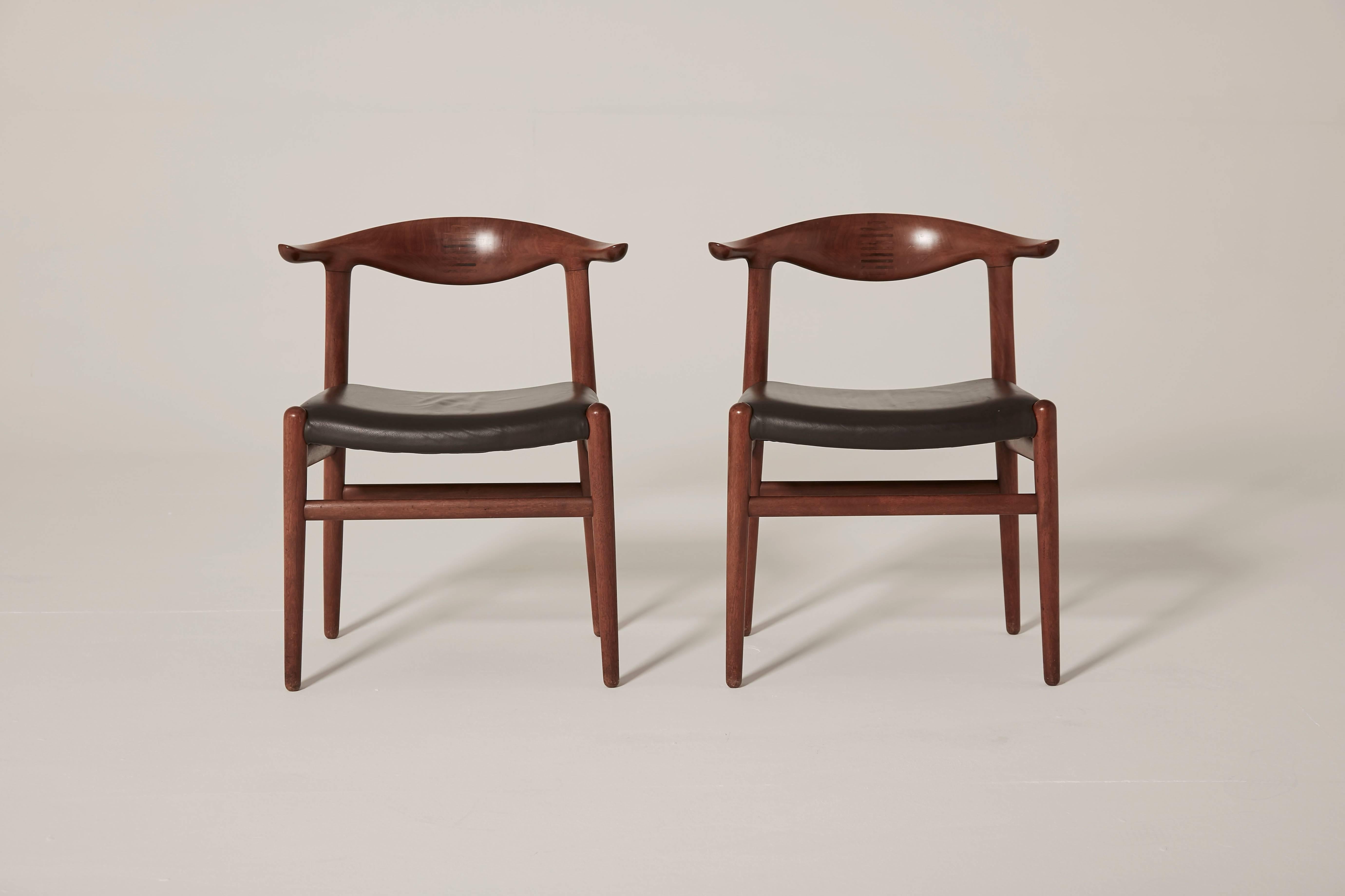 Hans Wegner cow horn (Kohornstol) Chairs model JH 505, made by Johannes Hansen, Denmark. Teak and rosewood inlay. Dark brown skai seats. Ships worldwide - please contact us for options. If you are looking for a cane seated version of this chair