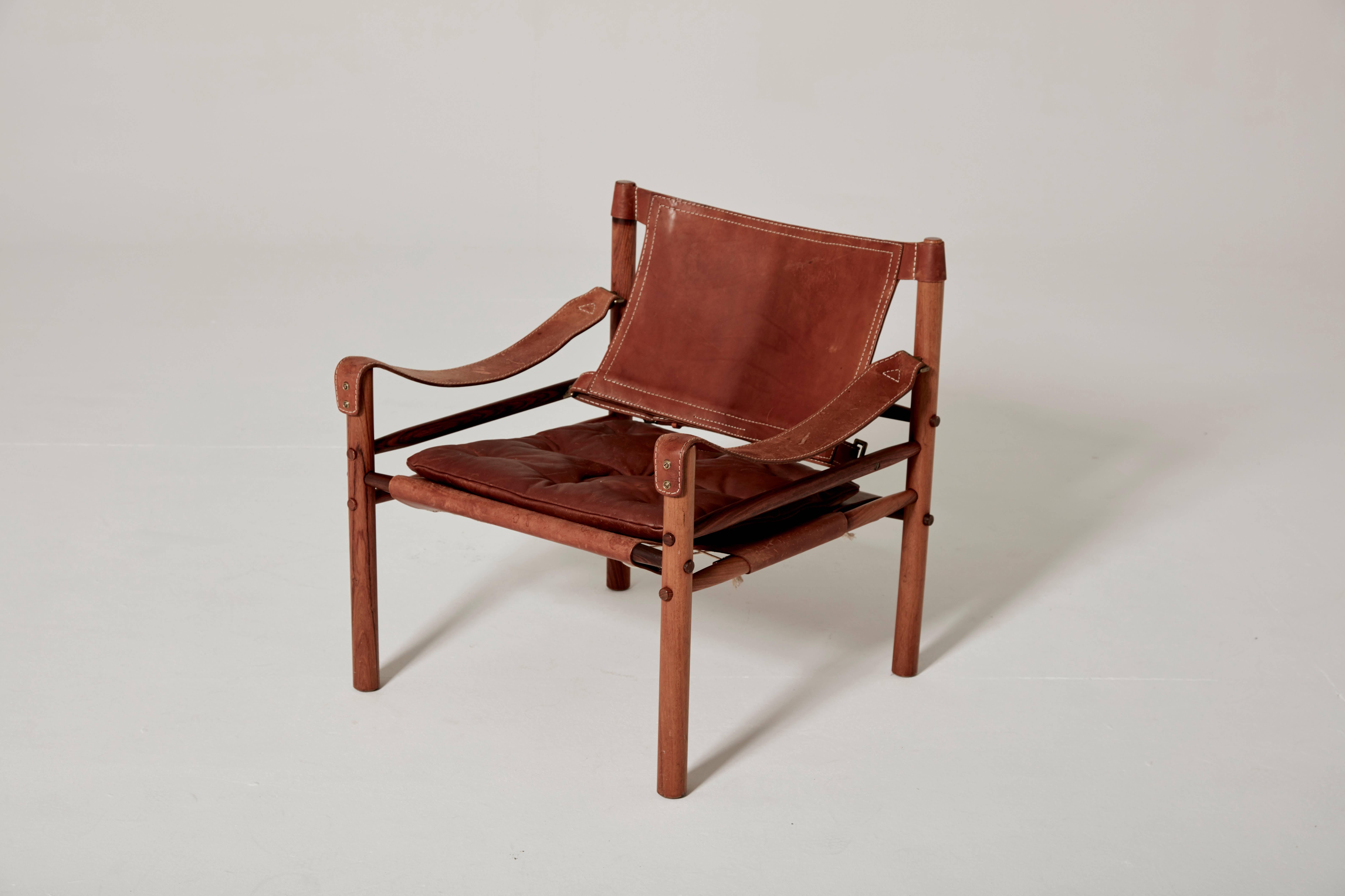 Arne Norell safari chair, brown leather and rosewood, Sweden, 1970s.