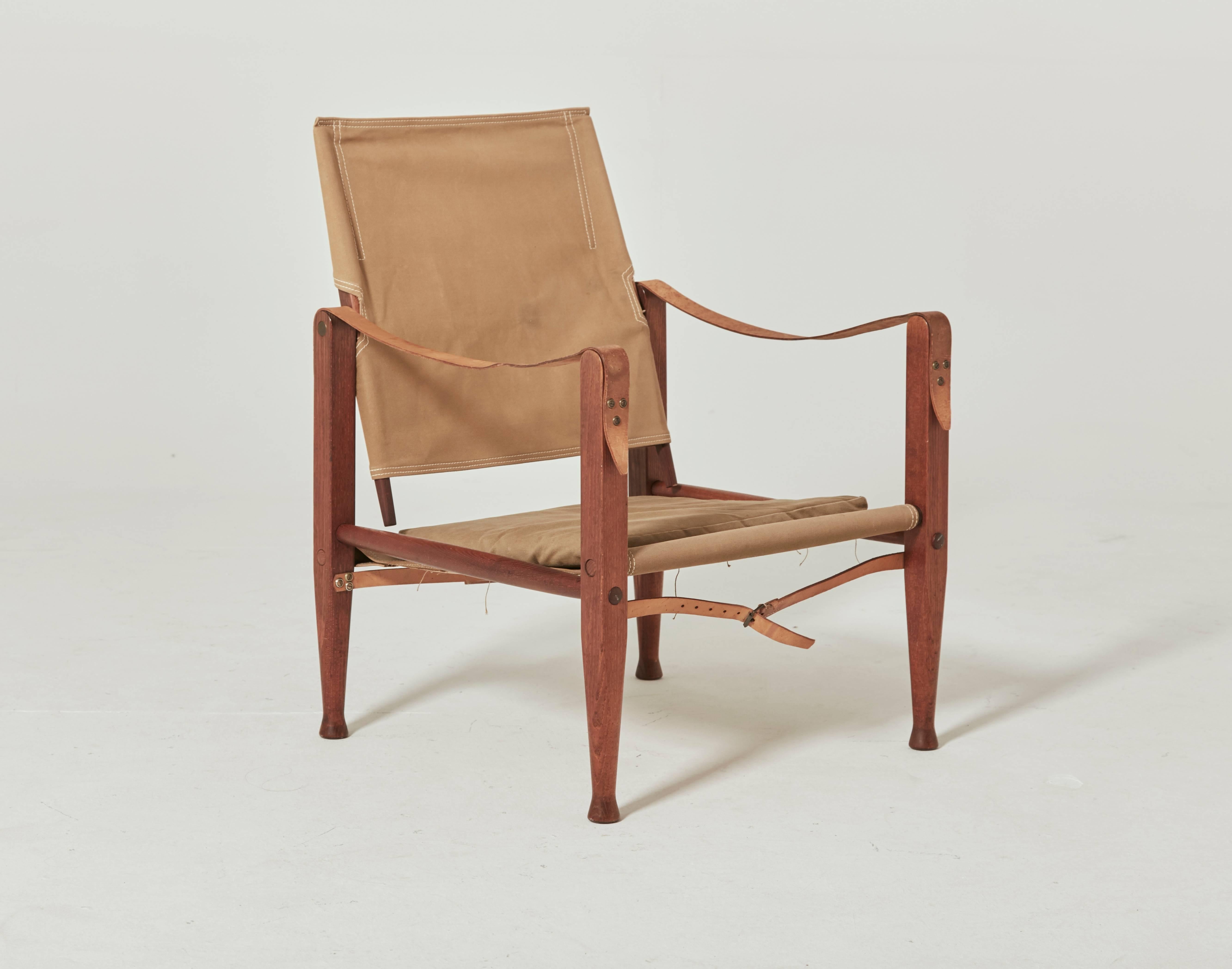 A Kaare Klint safari chair, made by Rud Rasmussen, Denmark. Original faded khaki canvas and ashwood. Ships worldwide.