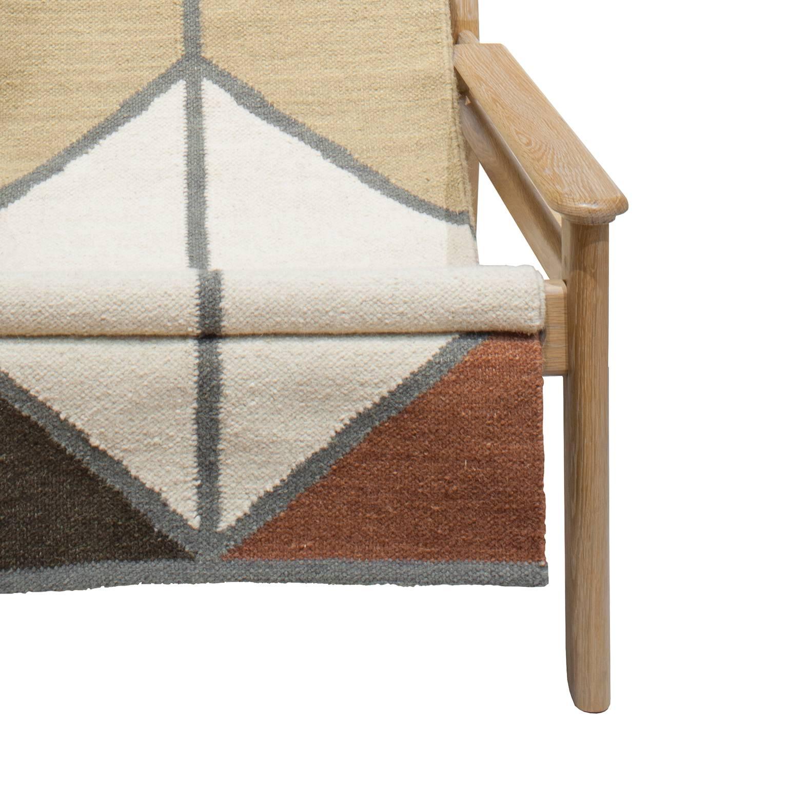 Cerused white oak lounge chair, woven wool rug sling seat. This special edition chair was designed for a museum exhibition at the Contemporary Art Museum of Houston.