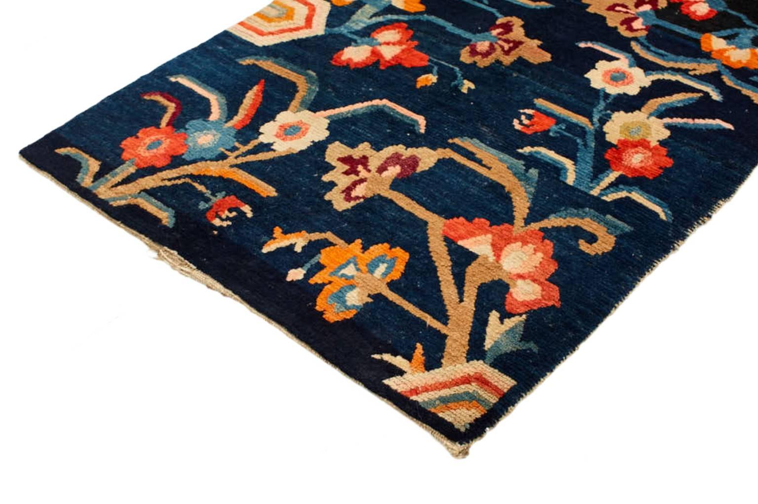 Individually selected by Madeline during her travels, this handwoven rug features floral elements that symbolize age-old Buddhist beliefs, representing purity, strength and spirituality. The distinctive palette of ivory, taupe, crimson and azure