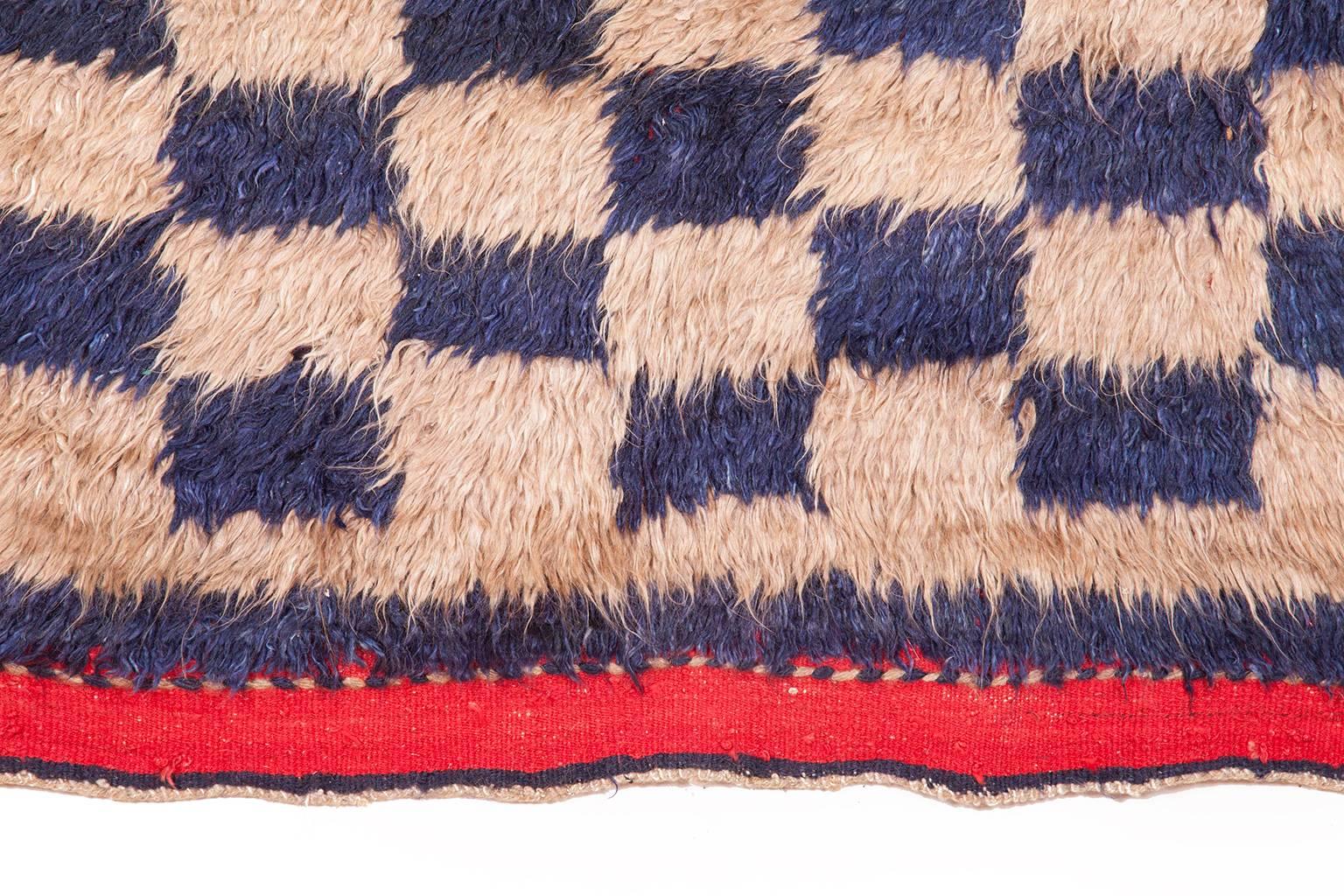 Individually selected by Madeline during her travels, this vintage Tulu carpet, handwoven in Turkey from handspun angora wool, has a luxurious tactile quality. Each carpet has been hand-dyed, resulting in tonal nuances inherent in the production