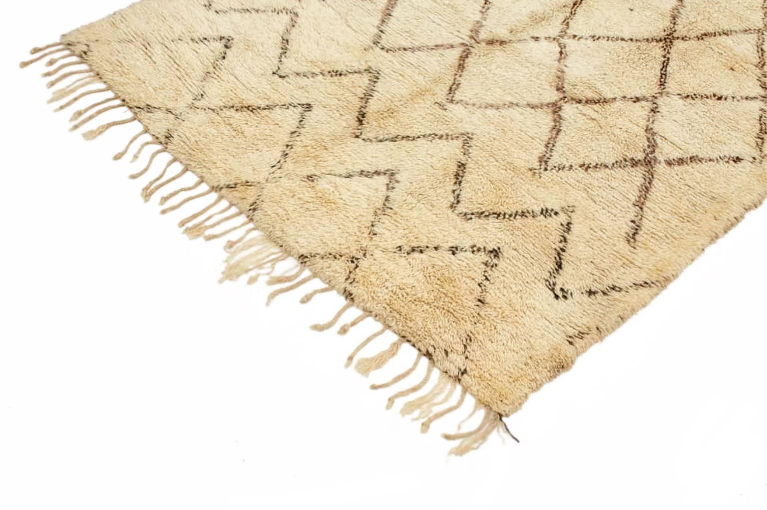Individually selected by Madeline during her travels, this timeless carpet has been made in the Atlas mountains of Morocco by the Beni Ourian and Berber tribes. Hand-knotted with hand-spun wool.