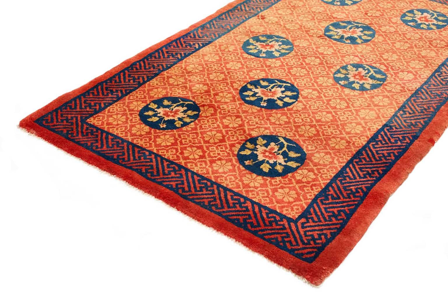 Individually selected by Madeline during her travels, this vintage Pao Tu rug features traditional floral medallions against a richly colored ground. Navy accents and bright colors are distinct characteristics of Oriental carpets and create a focal
