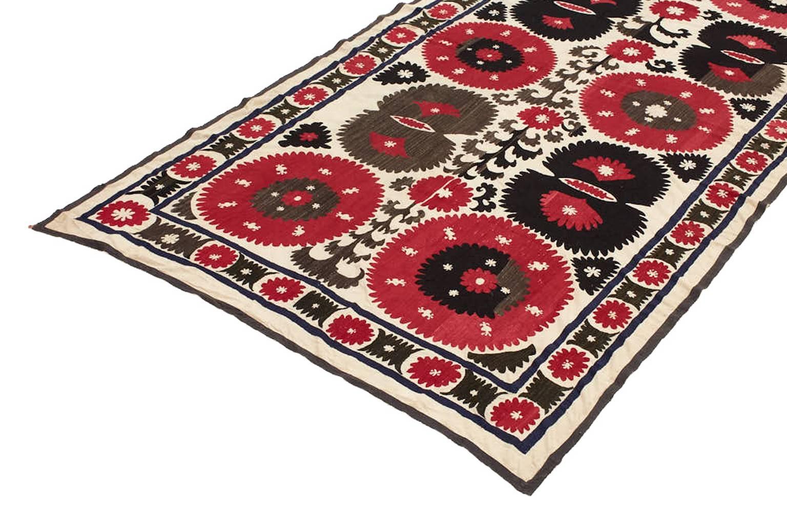 Individually selected by Madeline during her travels, this Suzani is intricately embroidered and the style has been crafted throughout Central Asia for centuries. Influenced by the rich commingling of cultures along the fabled Silk Road. Hand