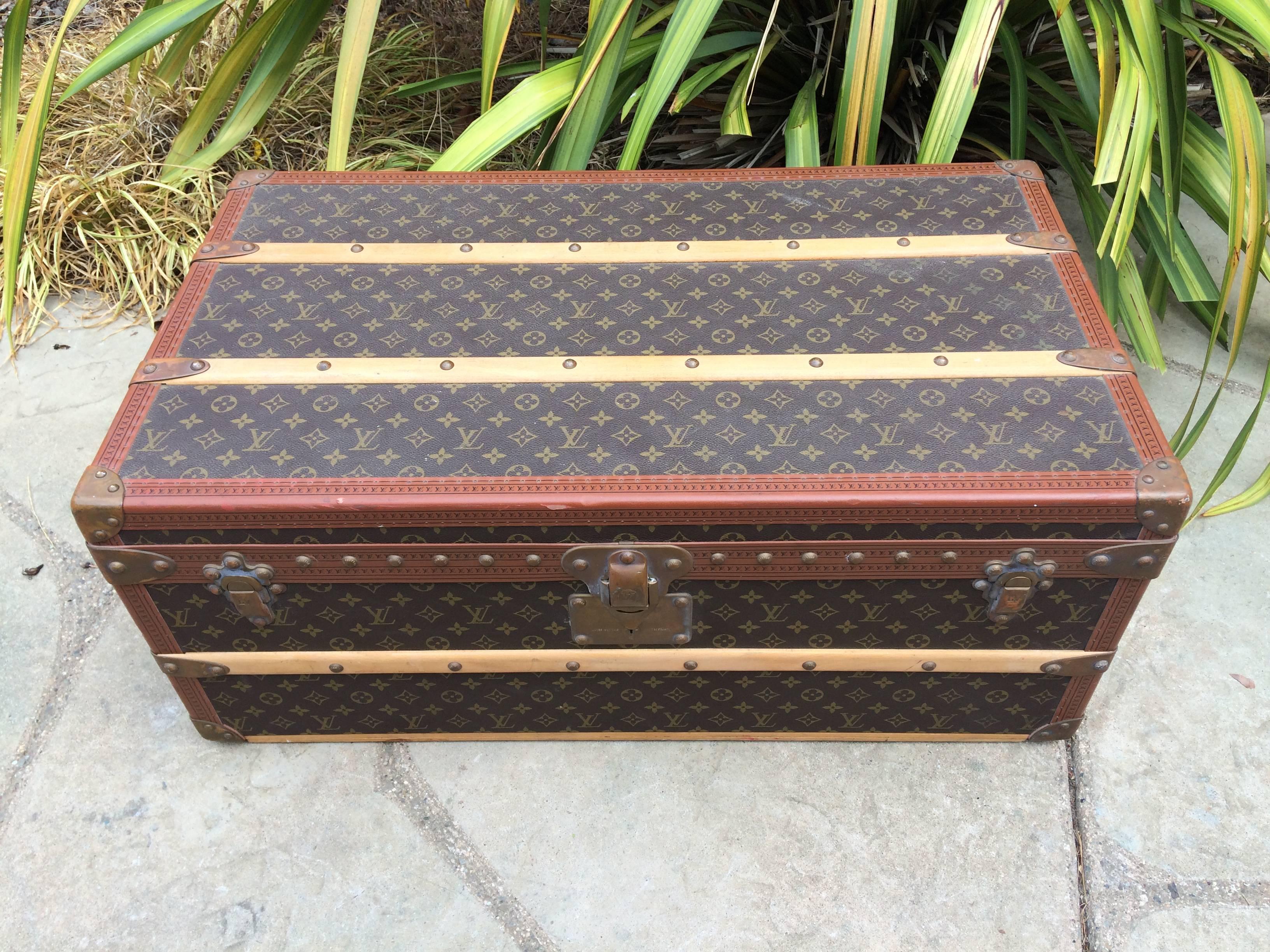 This gorgeous Louis Vuitton cabin trunk features Monogram canvas, LV lozine trim, stamped LV brass locks, LV stamped brass studs, brass corners, original leather side handles and two original working keys. It has got a warm and elegant patina.