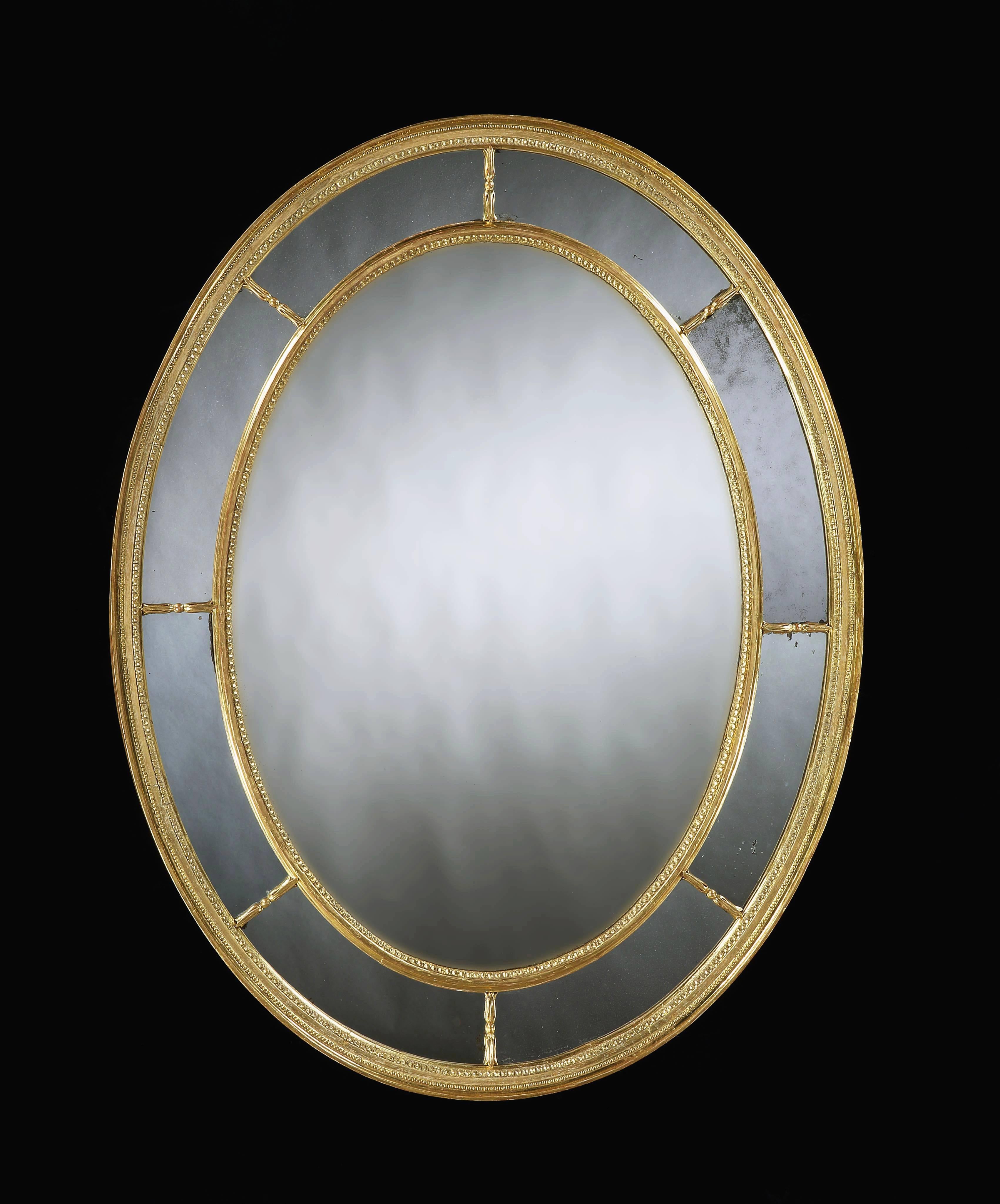 ​
A superbly proportioned oval, and rare large sized George III carved and gilded border glass mirror with fine carved detailing.
 
English, circa 1790.
​
Measures: Height 52" 133 cm,
width 41" 104 cm.
​
This well proportioned