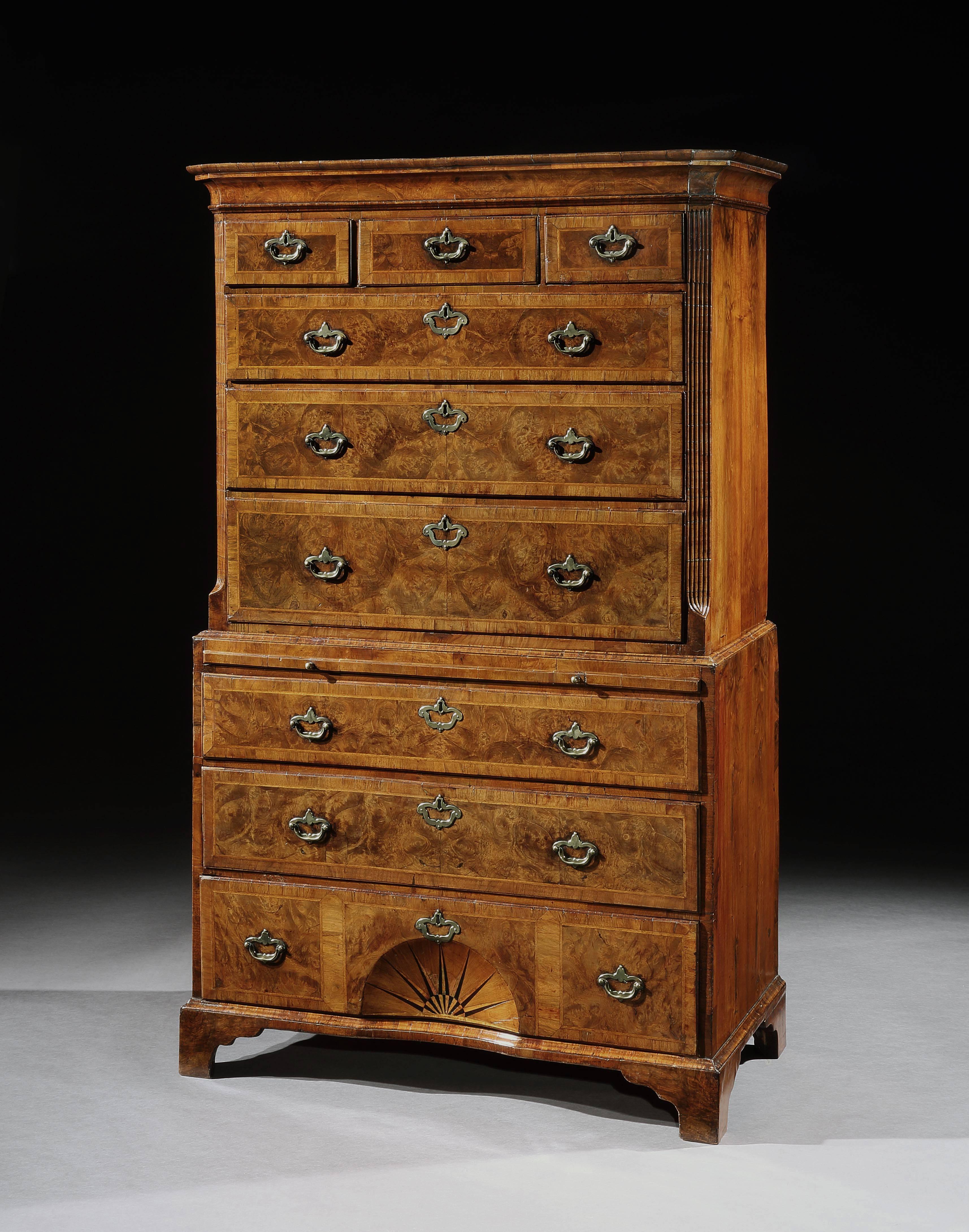 A good George I burr walnut tallboy, the upper part with canted corners above a brushing slide, the lower drawer with a inlaid sunburst.
             