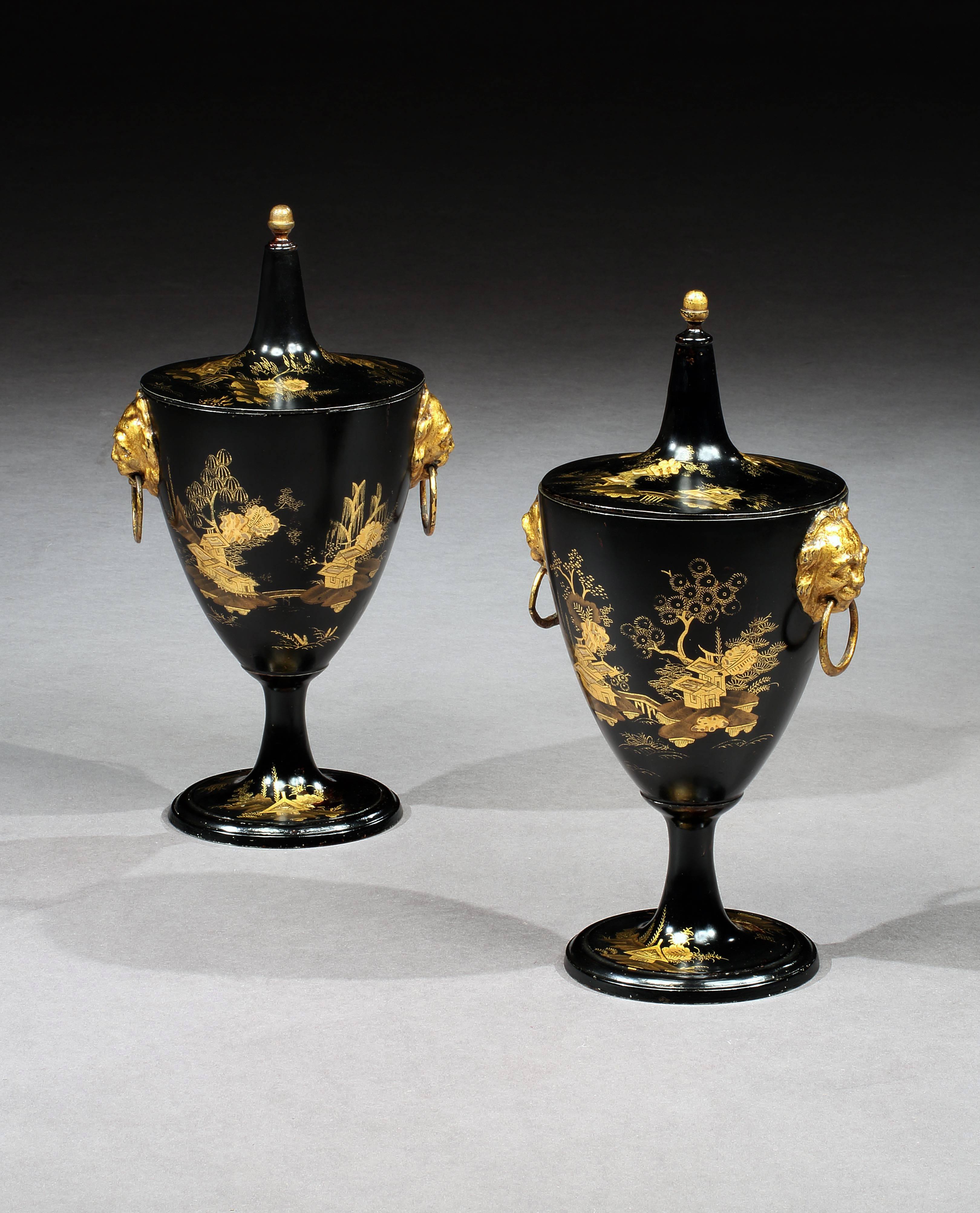 A quality pair of George III Regency pewter chestnut urns, decorated with houses and landscapes, with gilded lion mask ring handles.
 
English, circa 1800.