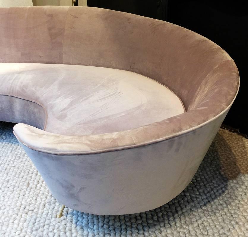 With new grey velvet upholstery and small iconic brass legs.