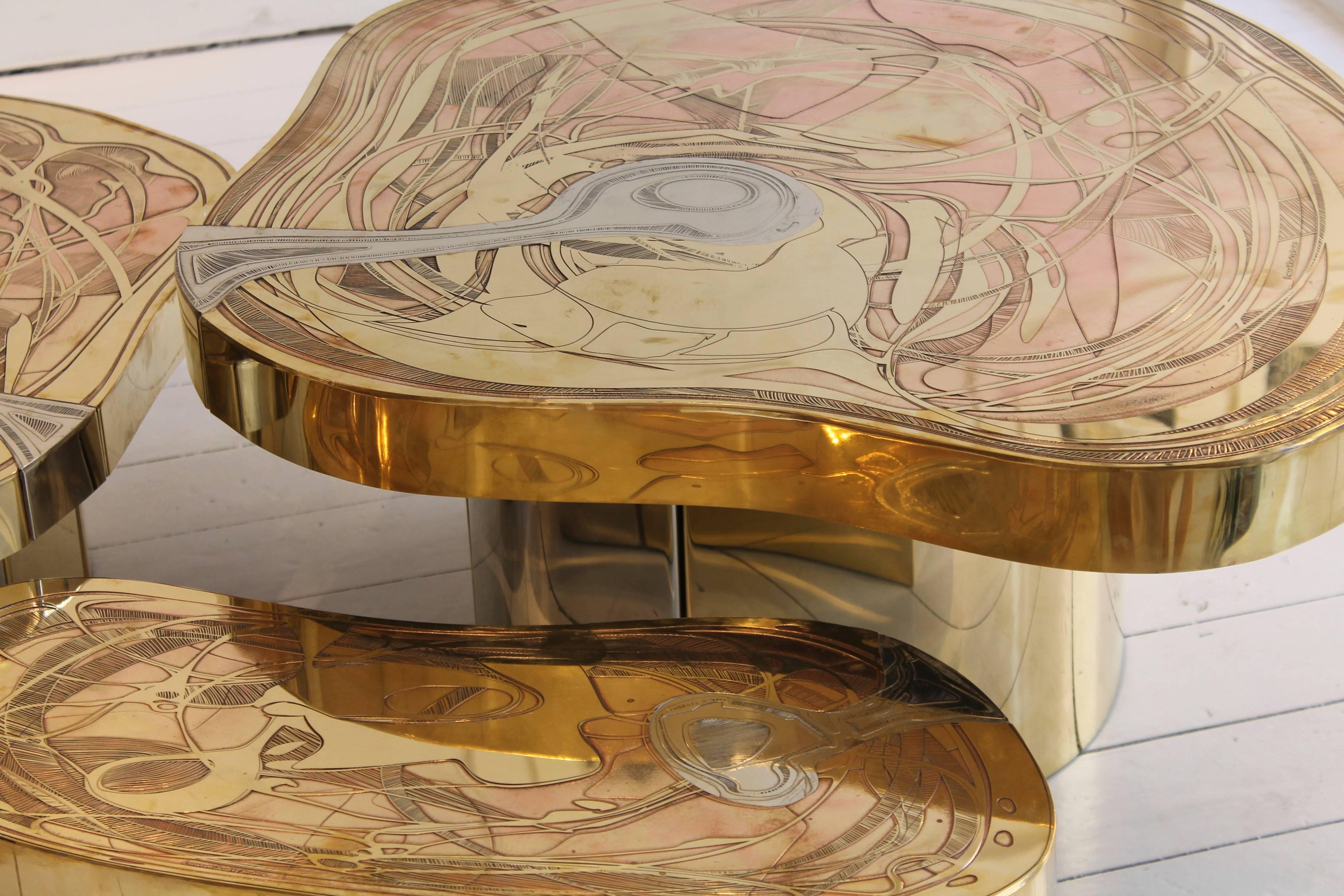 Set of three engraved brass coffee tables by contemporary designer Emmanuel Jonckers. Measures: (H) 21 x 61 x 25 cm
(H) 26 x 66 x 49 cm
(H) 32 x 86 x 75 cm.