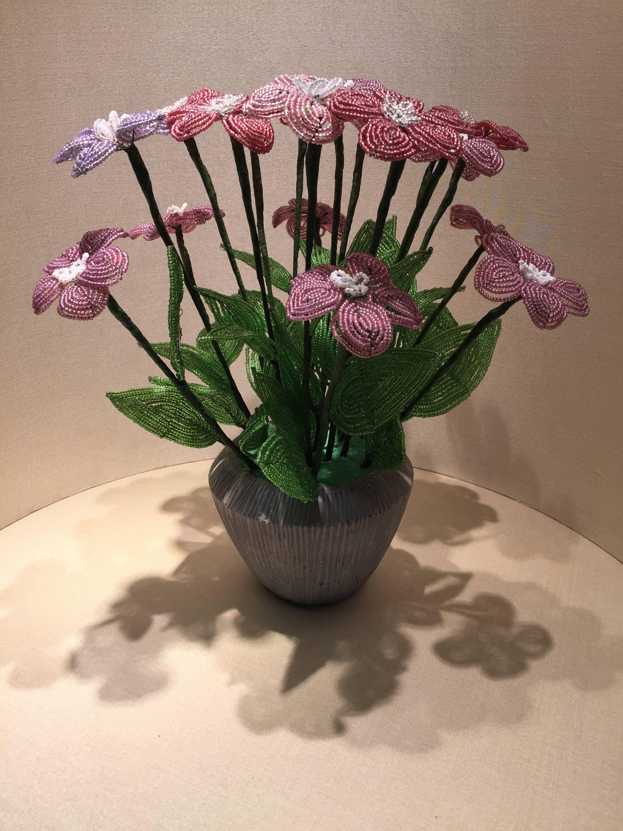 Beautiful beaded flowers put in a contemporary pot with grit bonded glass made early 20th century.