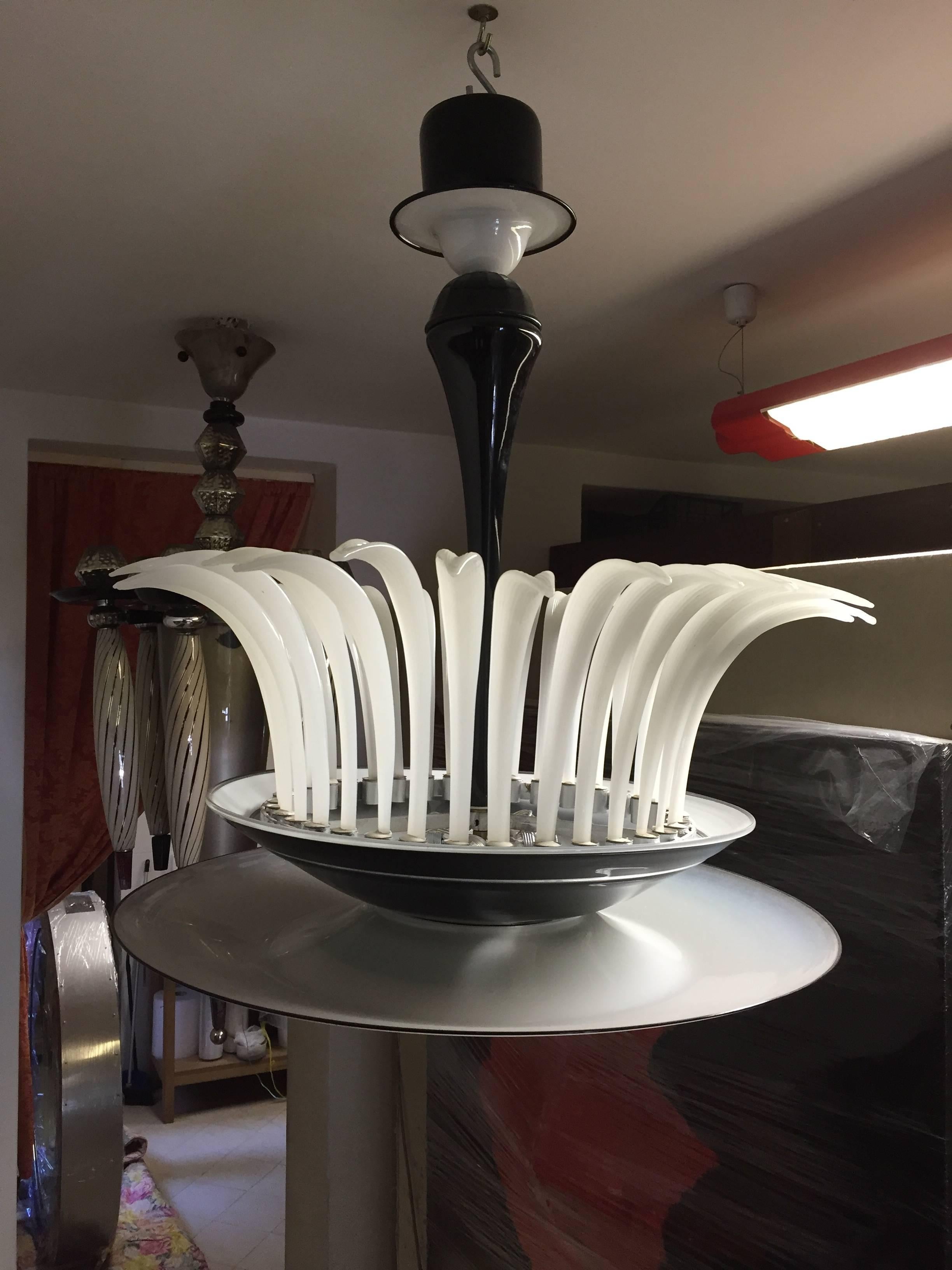 A stunning Murano glass chandelier formed by a big white bowl supported by a black dish with Greek decor engraved, a black bowl covers the metal structure that contains the leaves in opal glass.