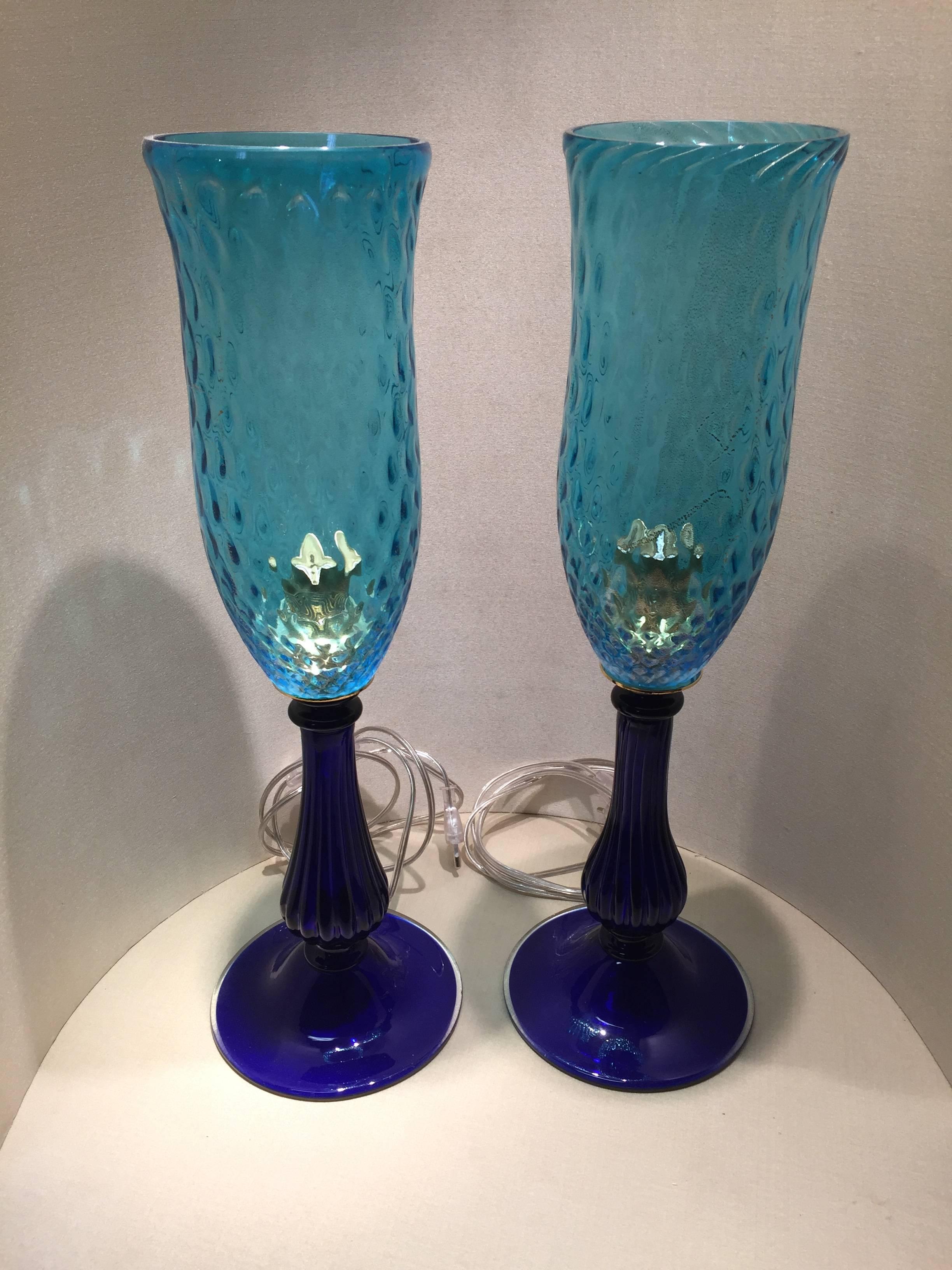 A very nice couple of lamps with aquamarine color Murano glass shades on cobalt blue blown glass fluted foot.