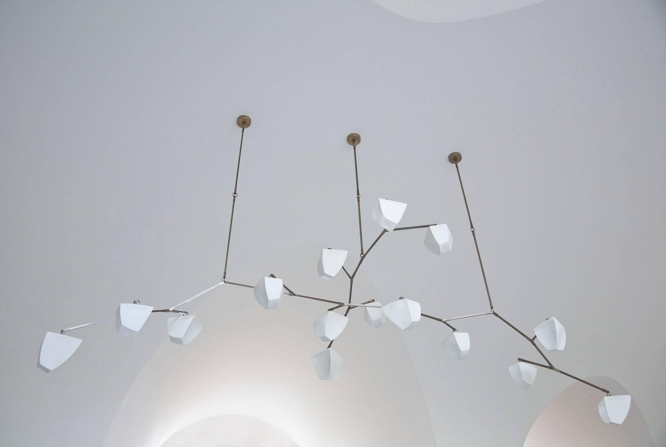 Cassiopeia 15: Porcelain is a show-stopping 3 stem Chandelier with 15 glowing hand-cast unglazed porcelain polyhedrons. Stunning in any setting, this classy piece of light-art offers charm, depth,  and warmth.

This fixture can be customized with