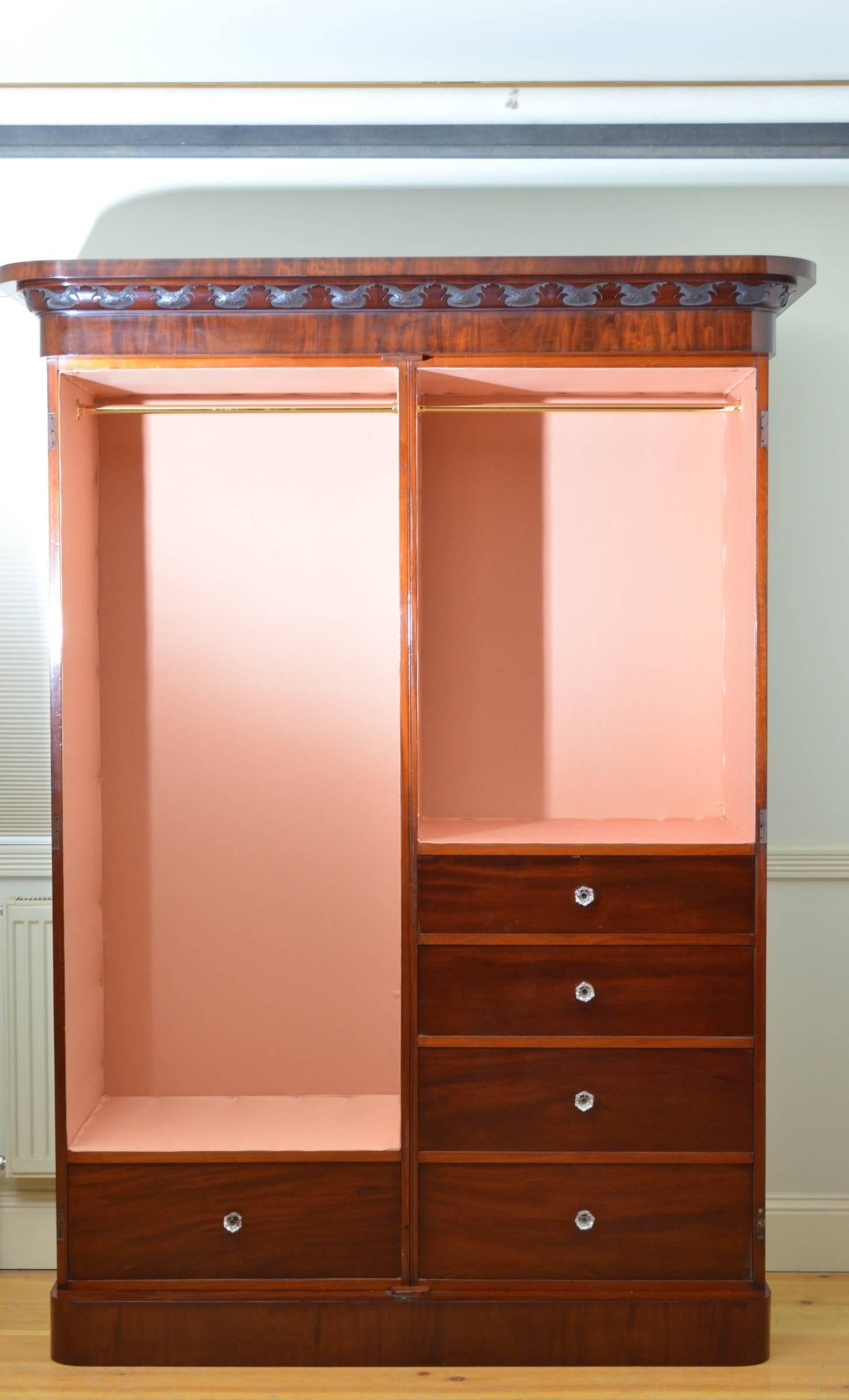 Sn3996, a fine quality and very elegant Victorian two-door solid wardrobe in mahogany having cavetto cornice with finely card fretwork to frieze and a pair of arched and panelled figured mahogany doors fitted with working lock and key enclosing