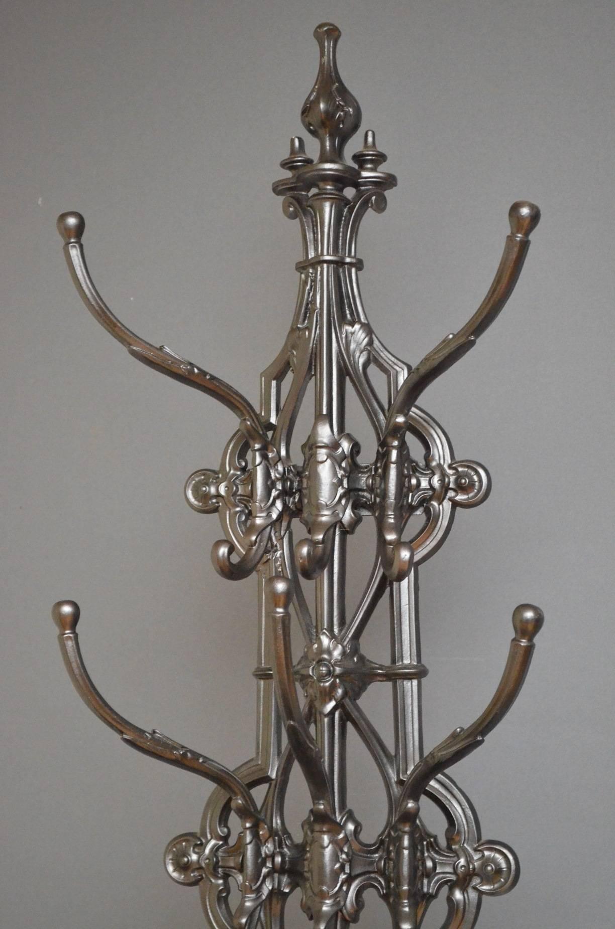 K0107. A striking Victorian Coalbrookdale hall stand of elaborate Renaissance design, having five coat hooks with foliate shell accents, tear drop shaped umbrella holders intricate pierced design to front and two shell shaped, removable trays to
