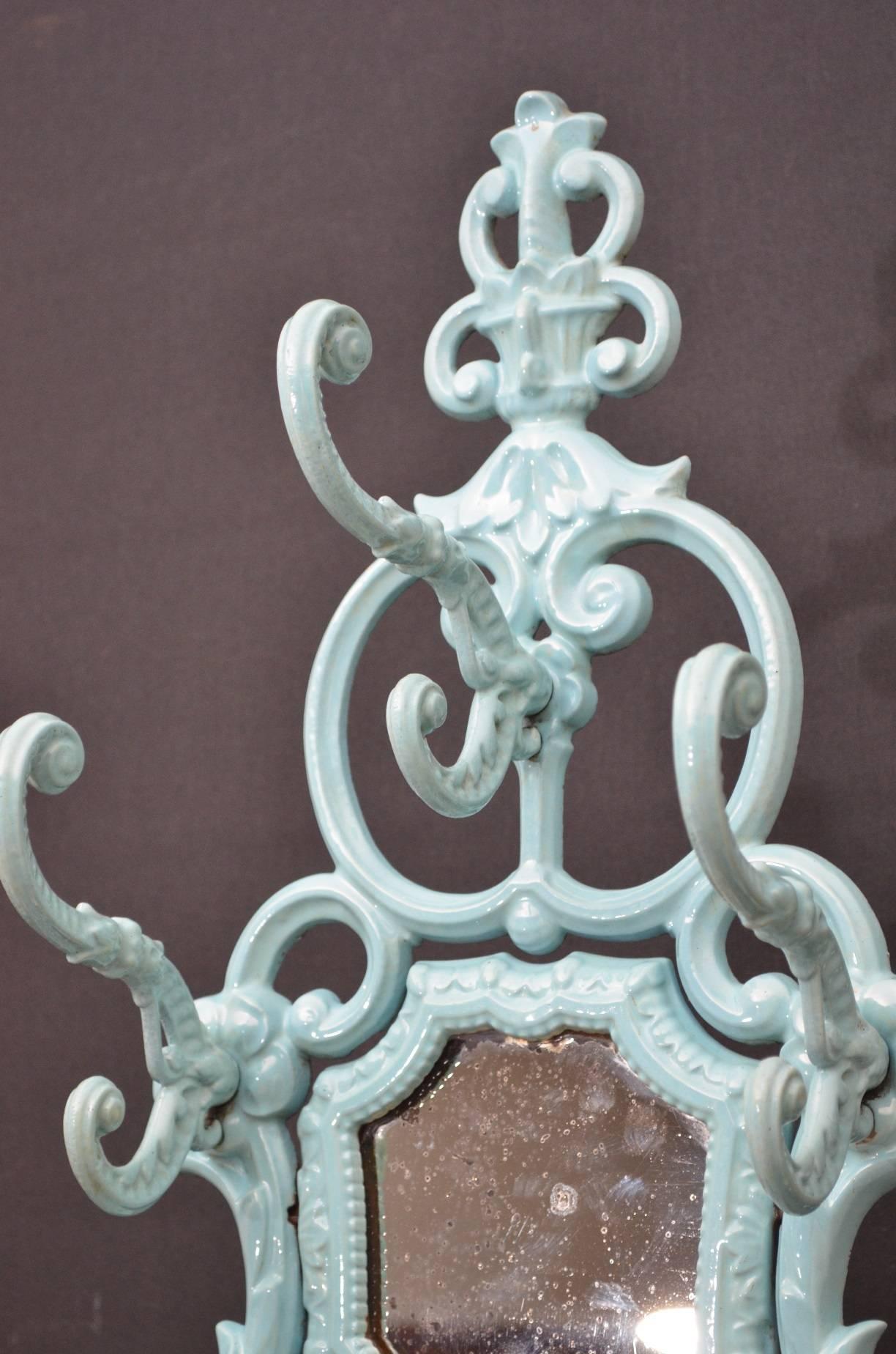 Sn3906 a striking Victorian, cast iron, enameled hall stand, having eight coat/hat hooks, original mirror and leaves, tendrils, flower decoration throughout, raise on elegant support terminating in shaped base with removable drip tray and decorative