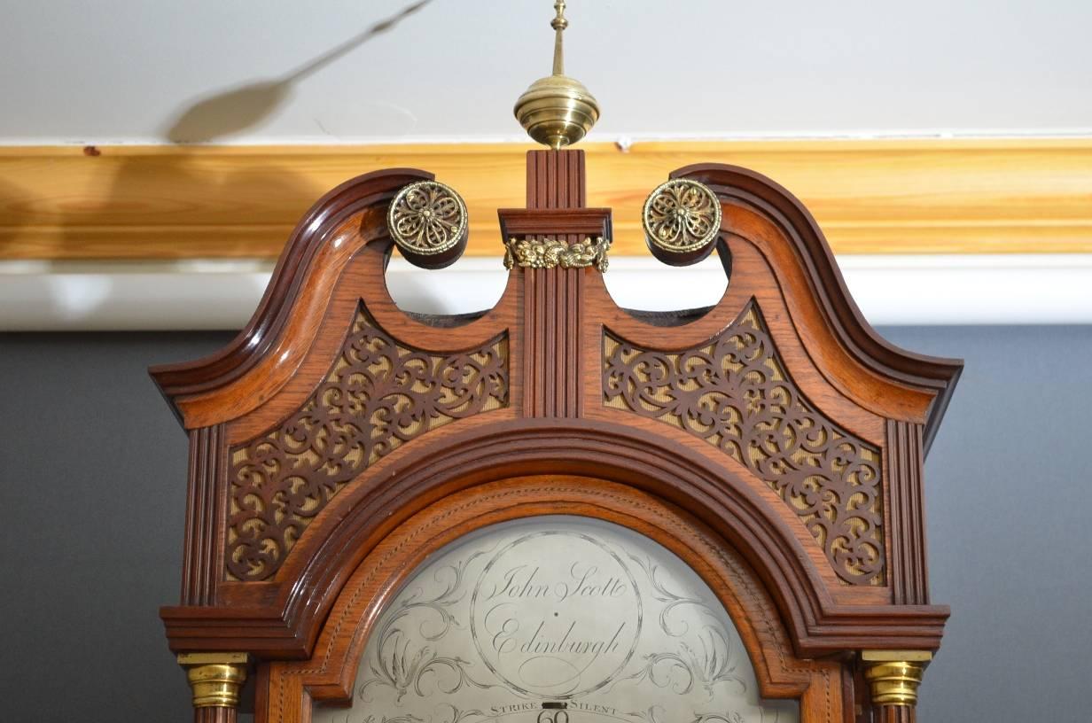 Stunning Georgian, oak and mahogany, longcase clock, having swan neck pediment with brass decoration and fretwork panels above a silvered dial signed by John Scott, Edinburgh with subsidiary seconds dial, all flanked by reeded and brass inlaid