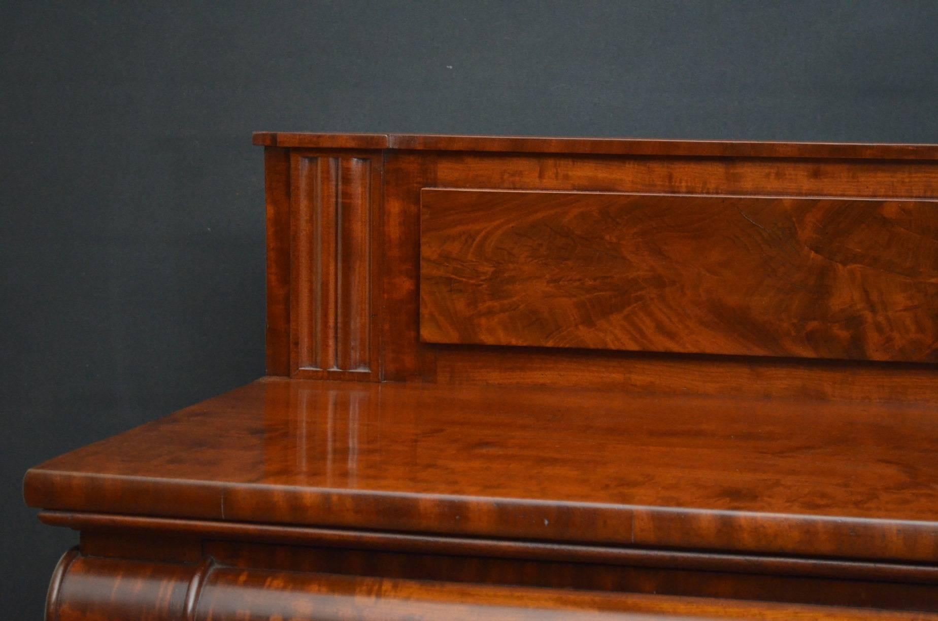 Sn3890, a striking, William IV, mahogany hall table, having flamed mahogany, fielded upstand with flanked by fluted decoration and stunning figured mahogany top above two cylindrical drawers, all raised on beautifully carved legs terminating in paw