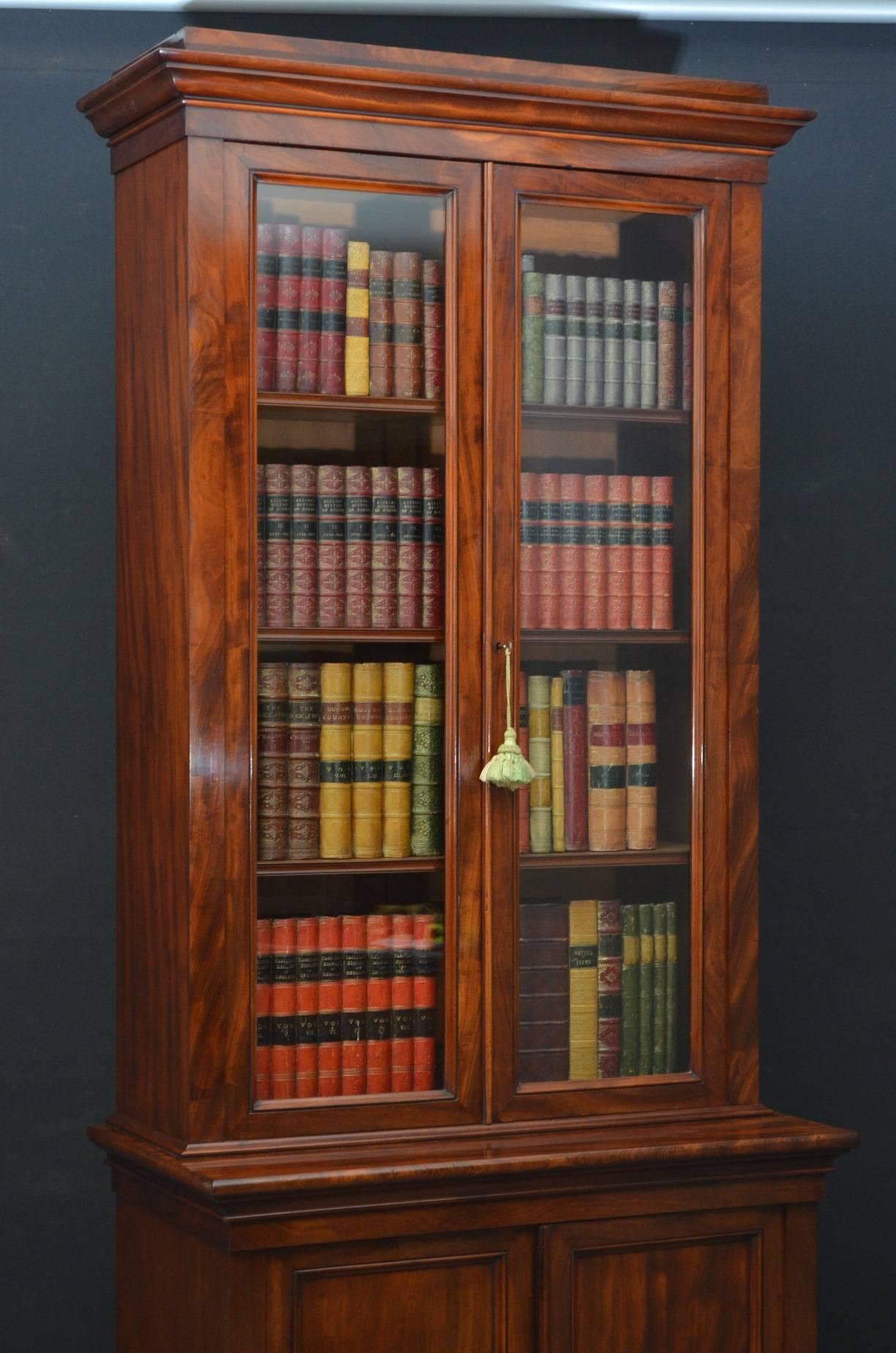Sn3895, a fine example of Victorian, mahogany bookcase chiffonier of elegant design, having cavetto cornice above a pair of glazed doors enclosing four height adjustable shelves and projecting base with panelled cupboard doors enclosing height